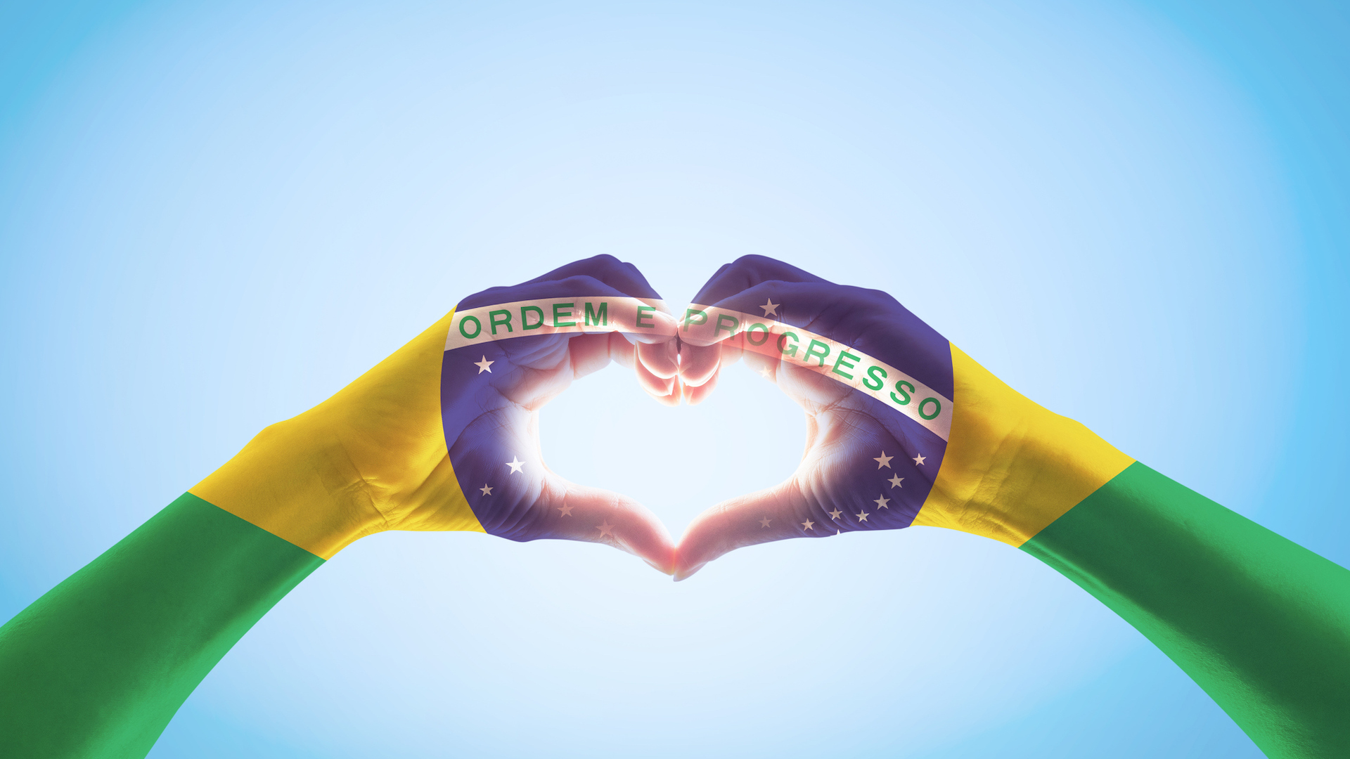 Brazil flag on someone's hands in heart shape