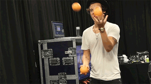 Harry Styles juggling oranges 