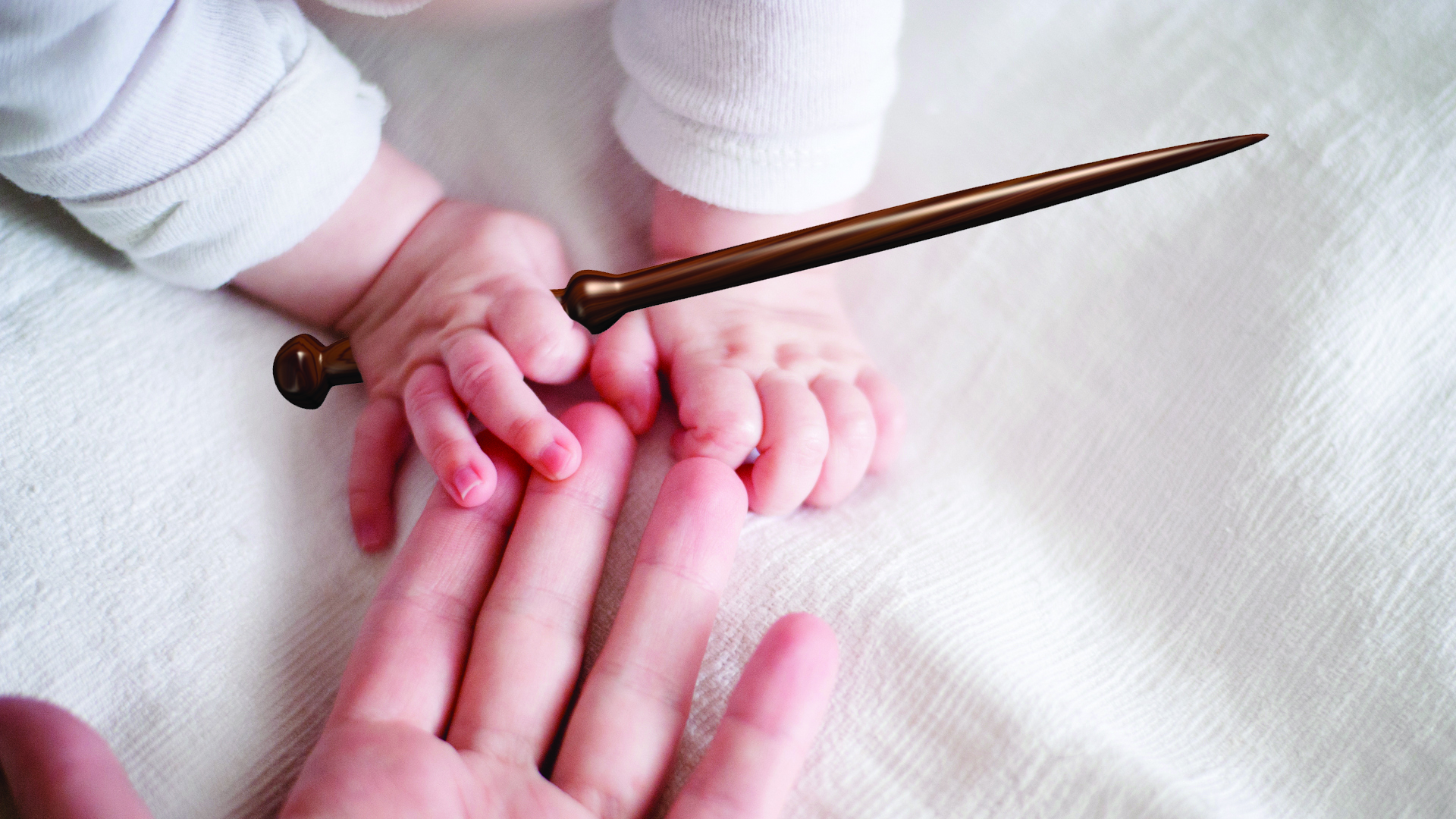 A baby holding a magic wand