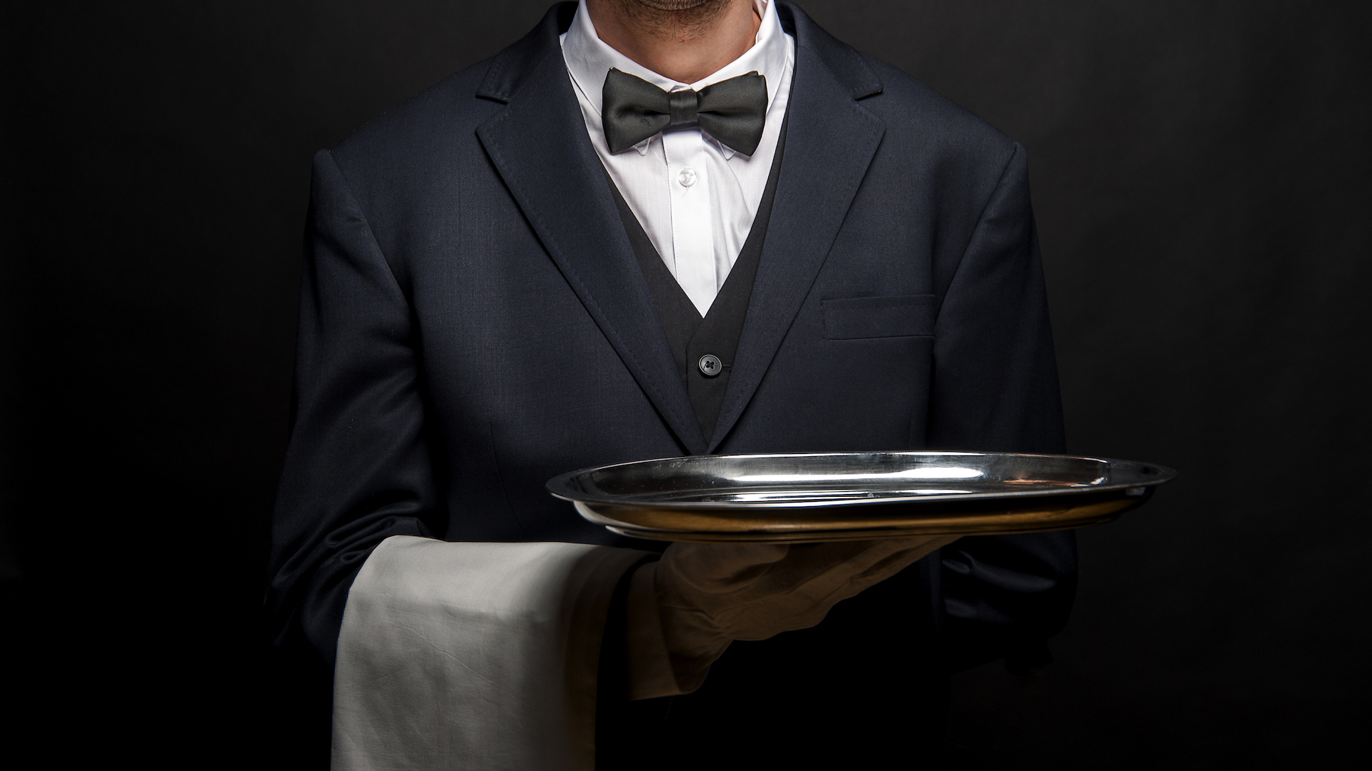 A butler holding a silver tray