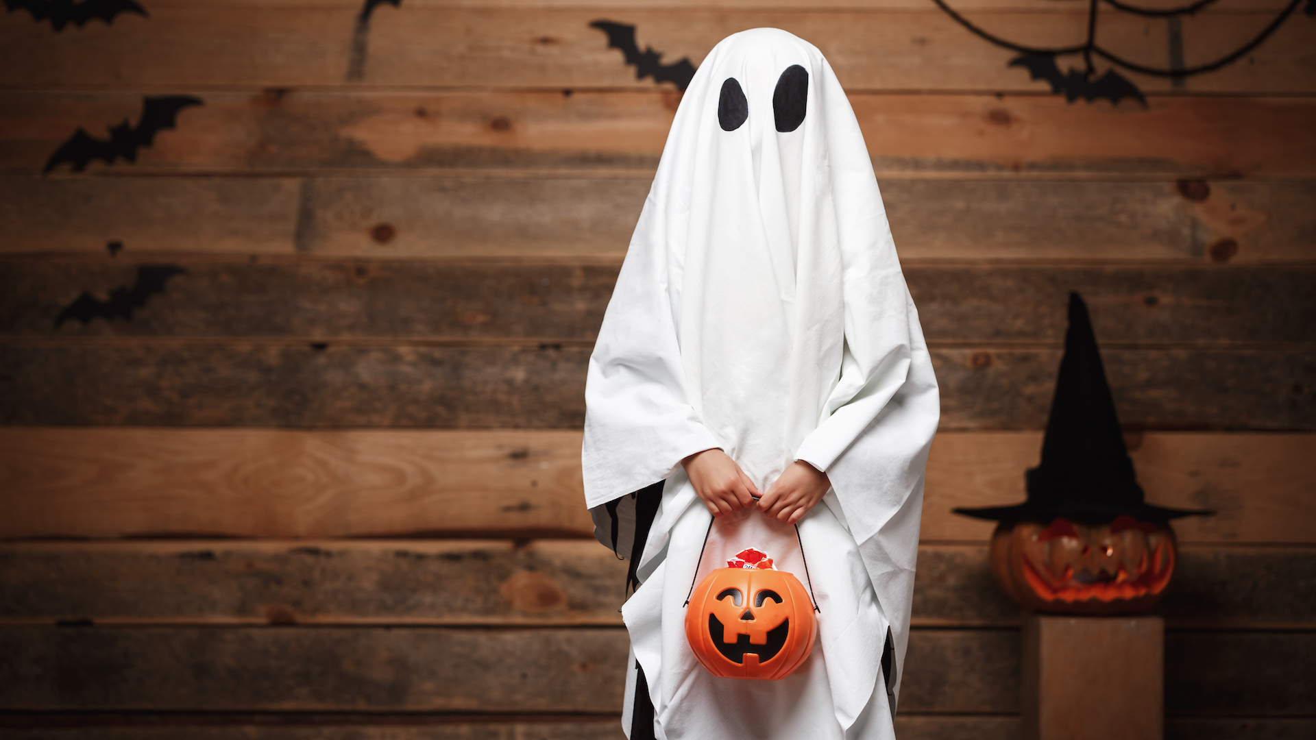 A child dressed as a ghost for Halloween