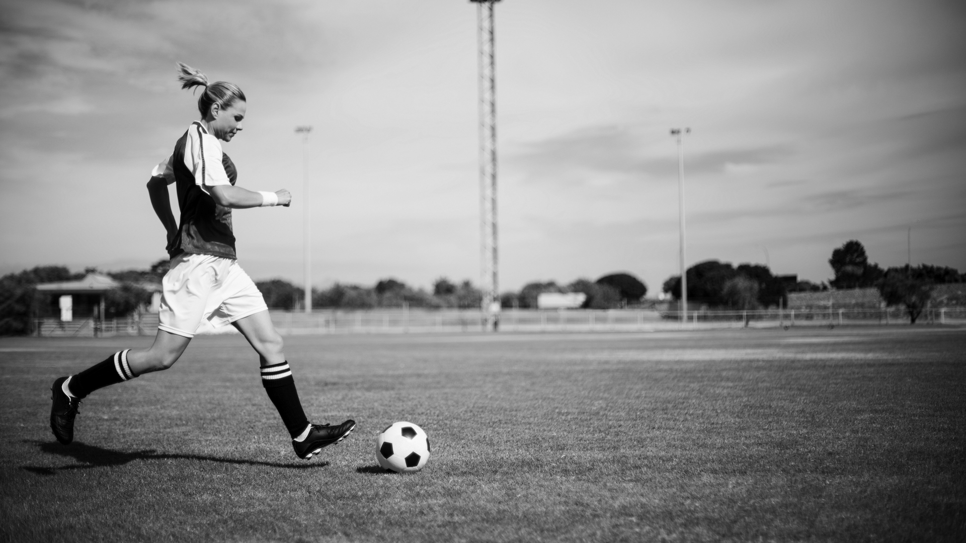 A black and white photo of a game of football