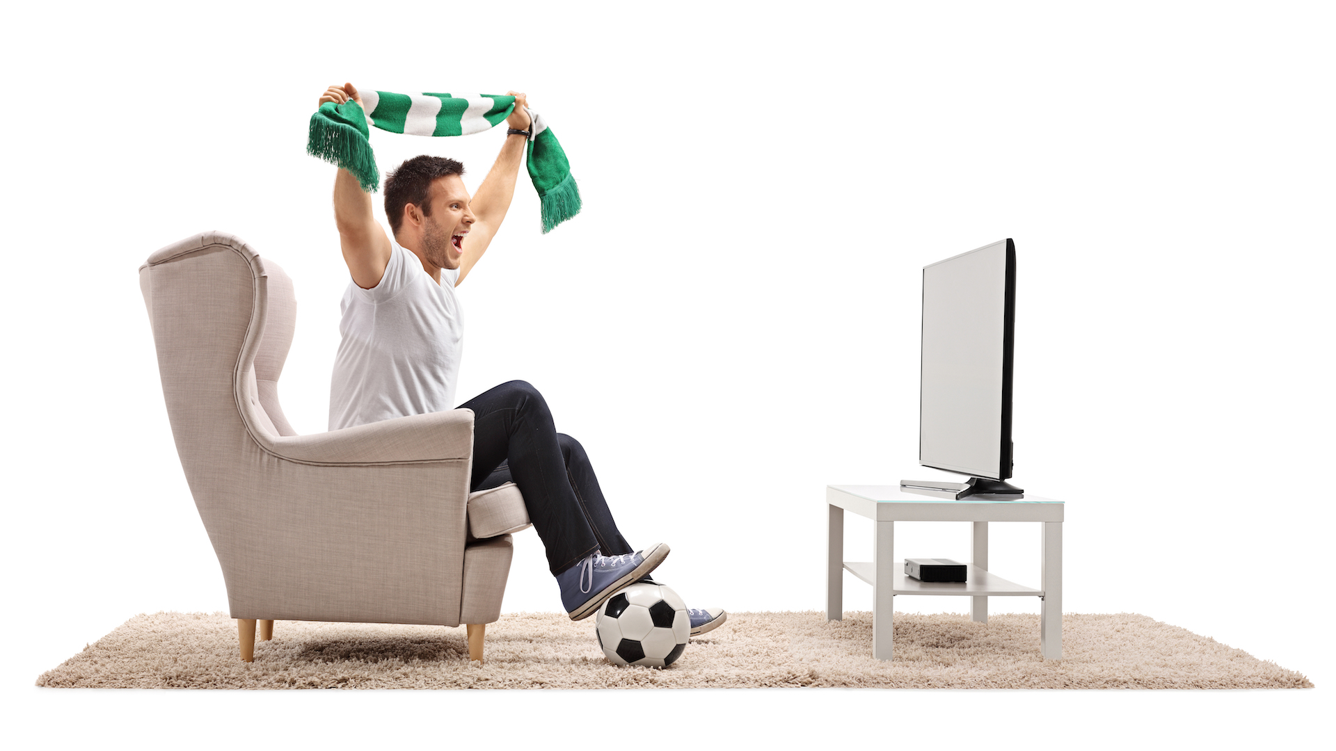 A football fan watching a game from his armchair