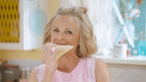 A woman enjoying a big slice of cake