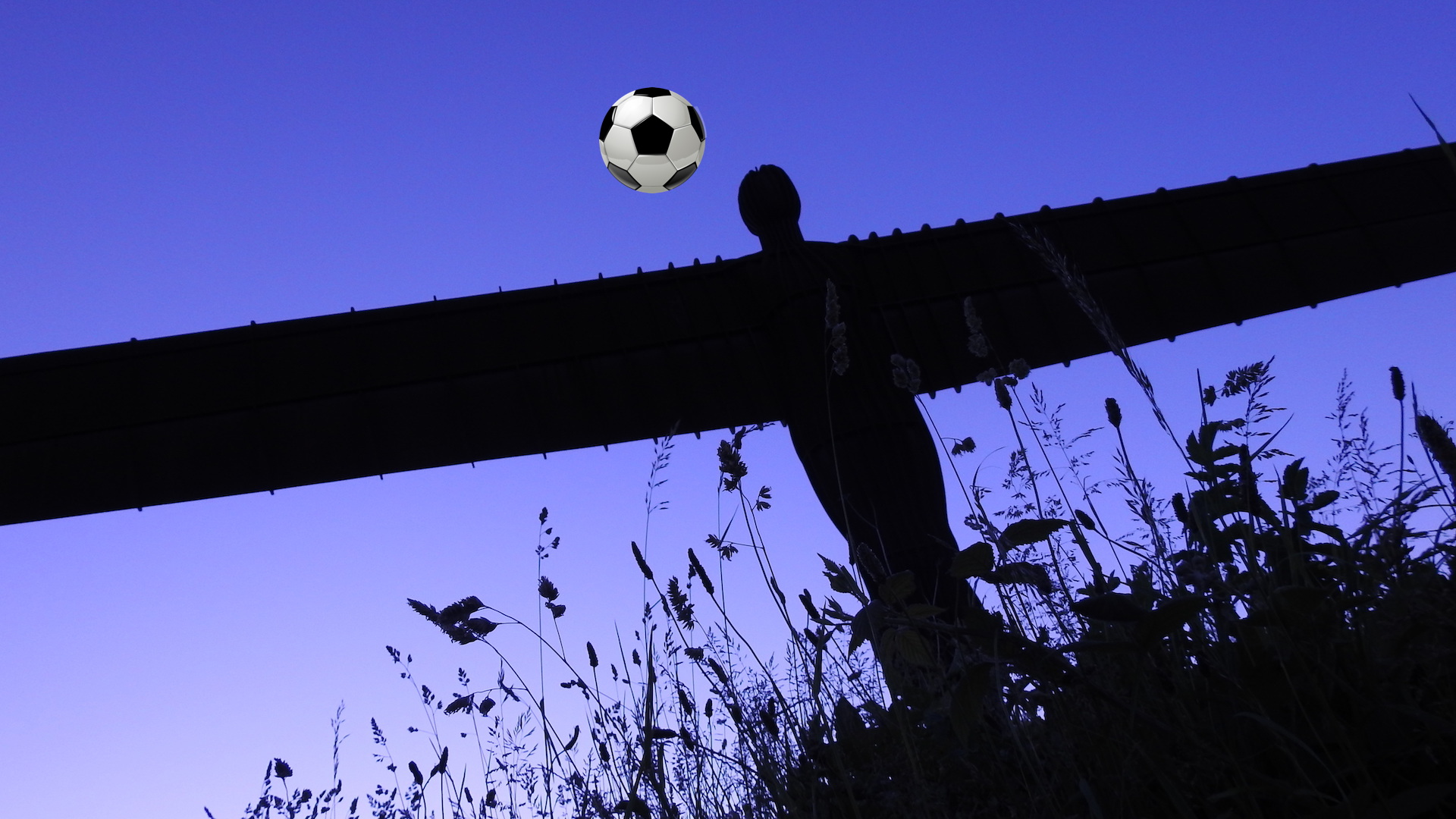 The Angel of the North heads a football