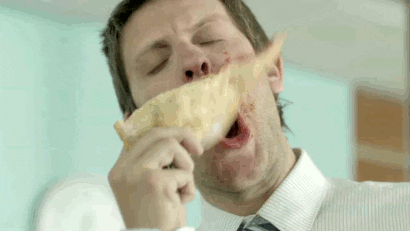A man eating a lively slice of pizza