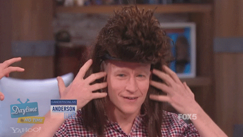 TV host Anderson Cooper wears a big wig