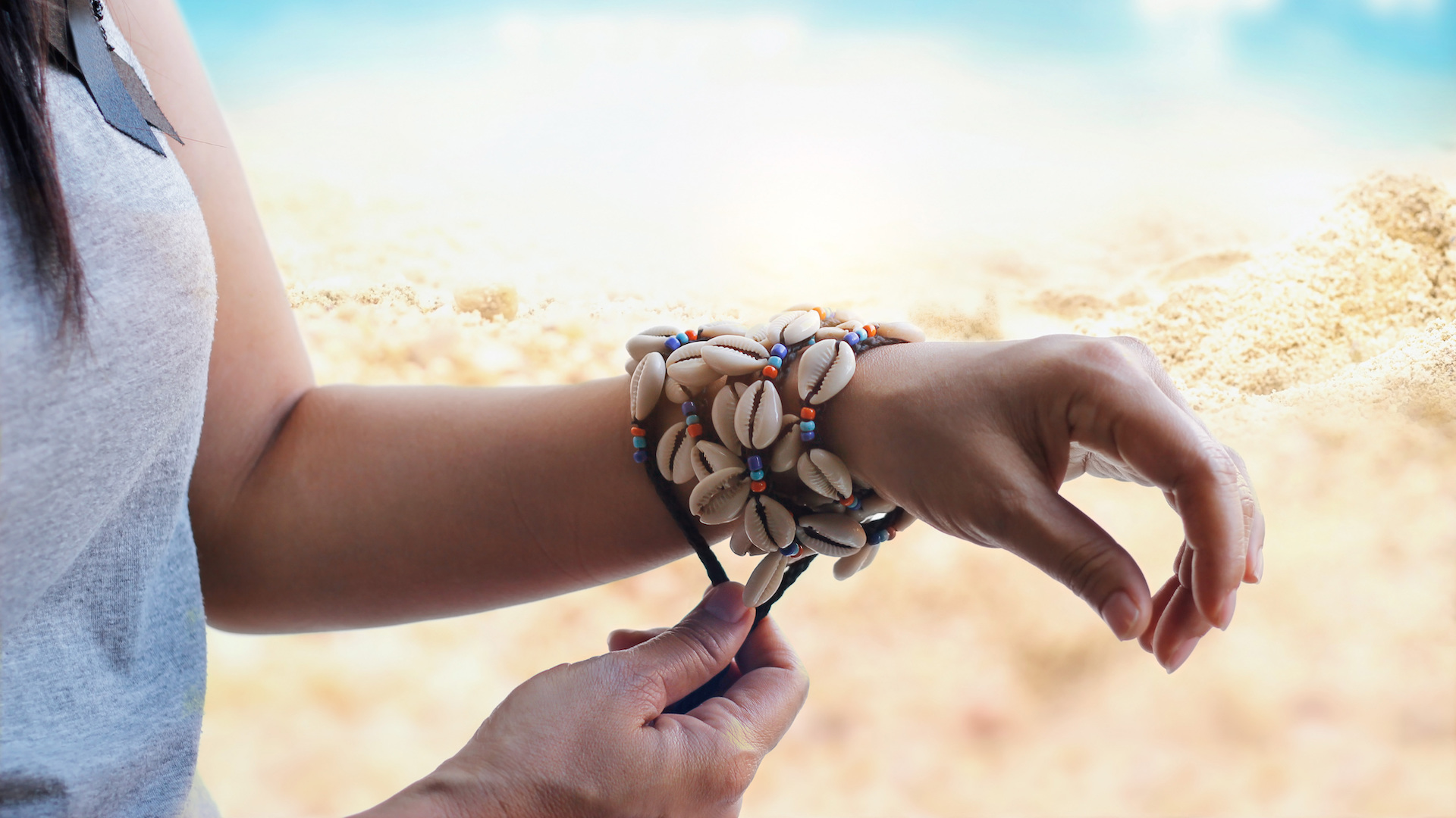 A shell bracelet on a woman's wrist
