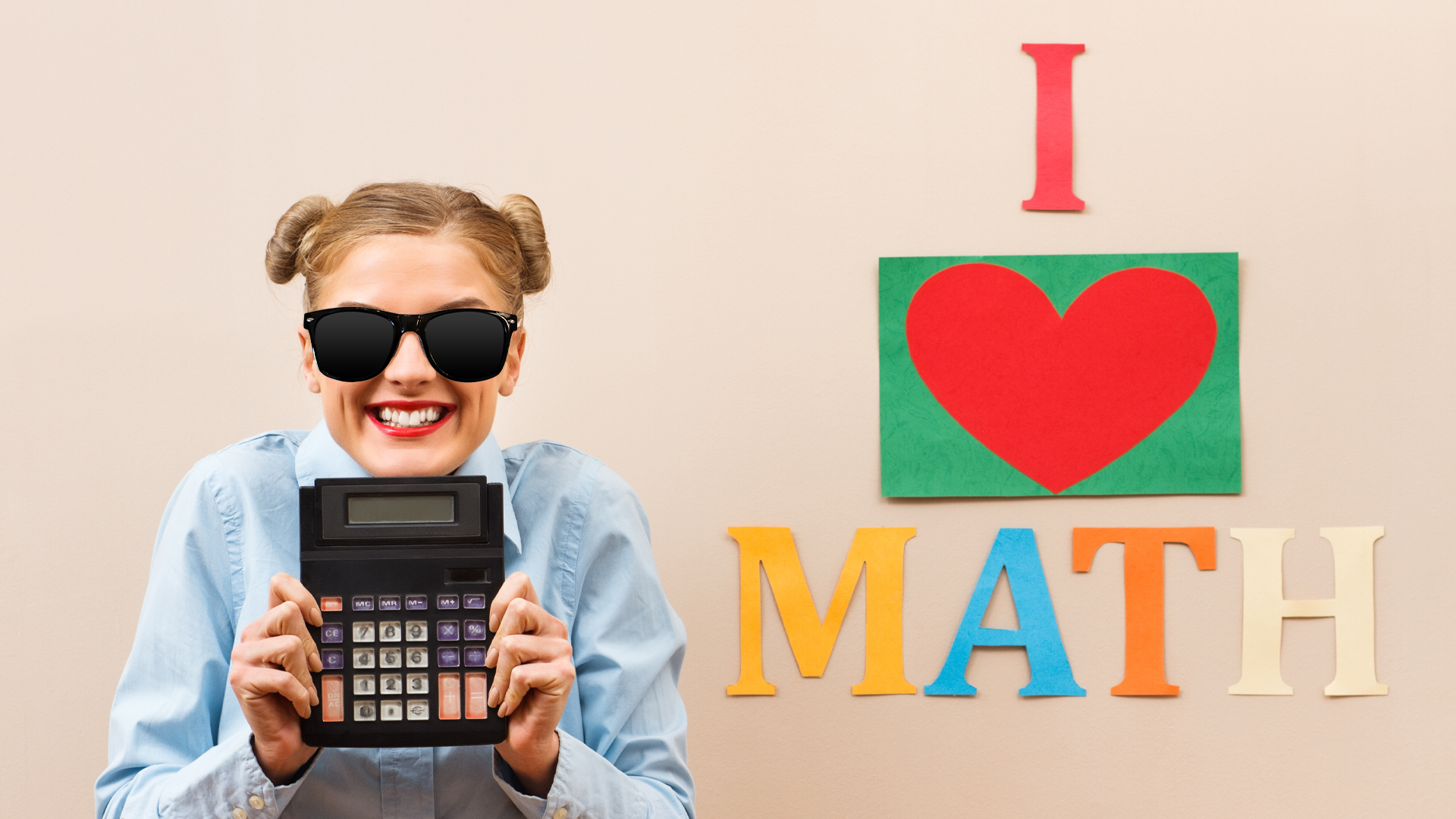 A woman standing next to a sign which reads 'I love math'