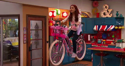Ariana Grande rides a bike in the air