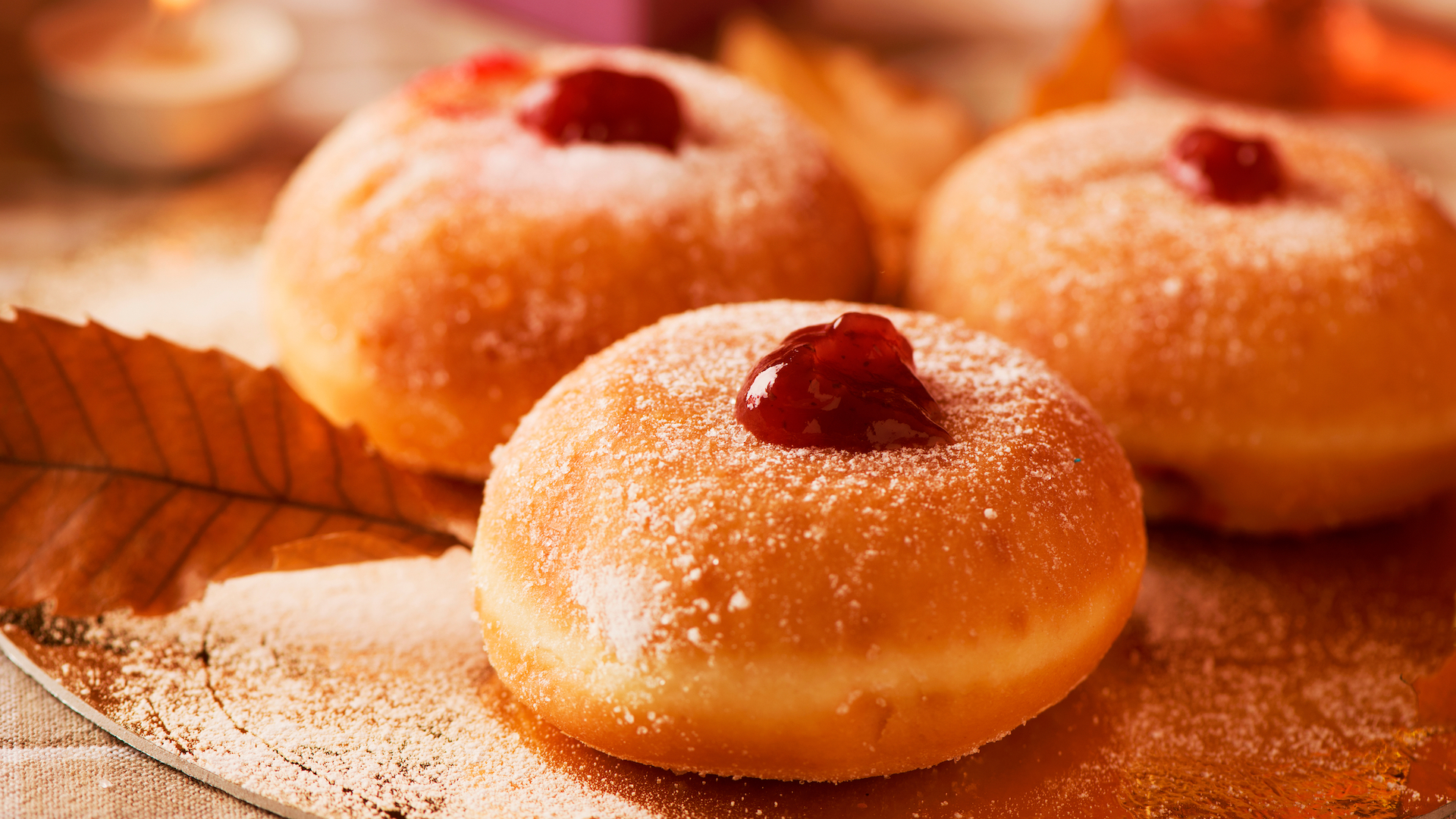 A closeup of some Jewish donuts filled with strawberry jelly