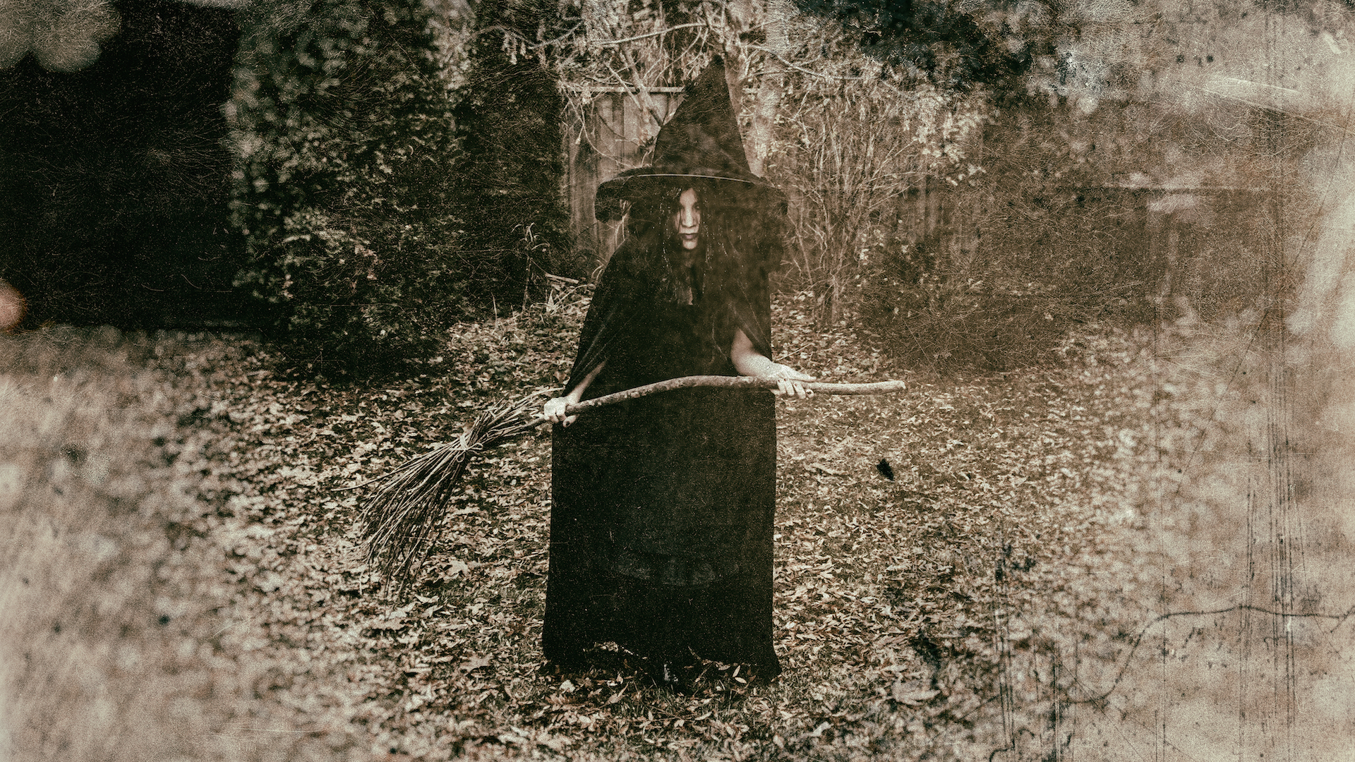 A black and white photograph of a witch