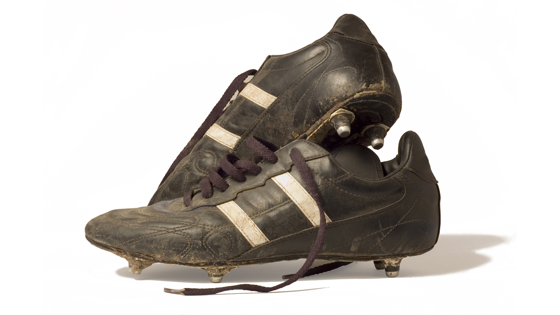 A pair of muddy football boots