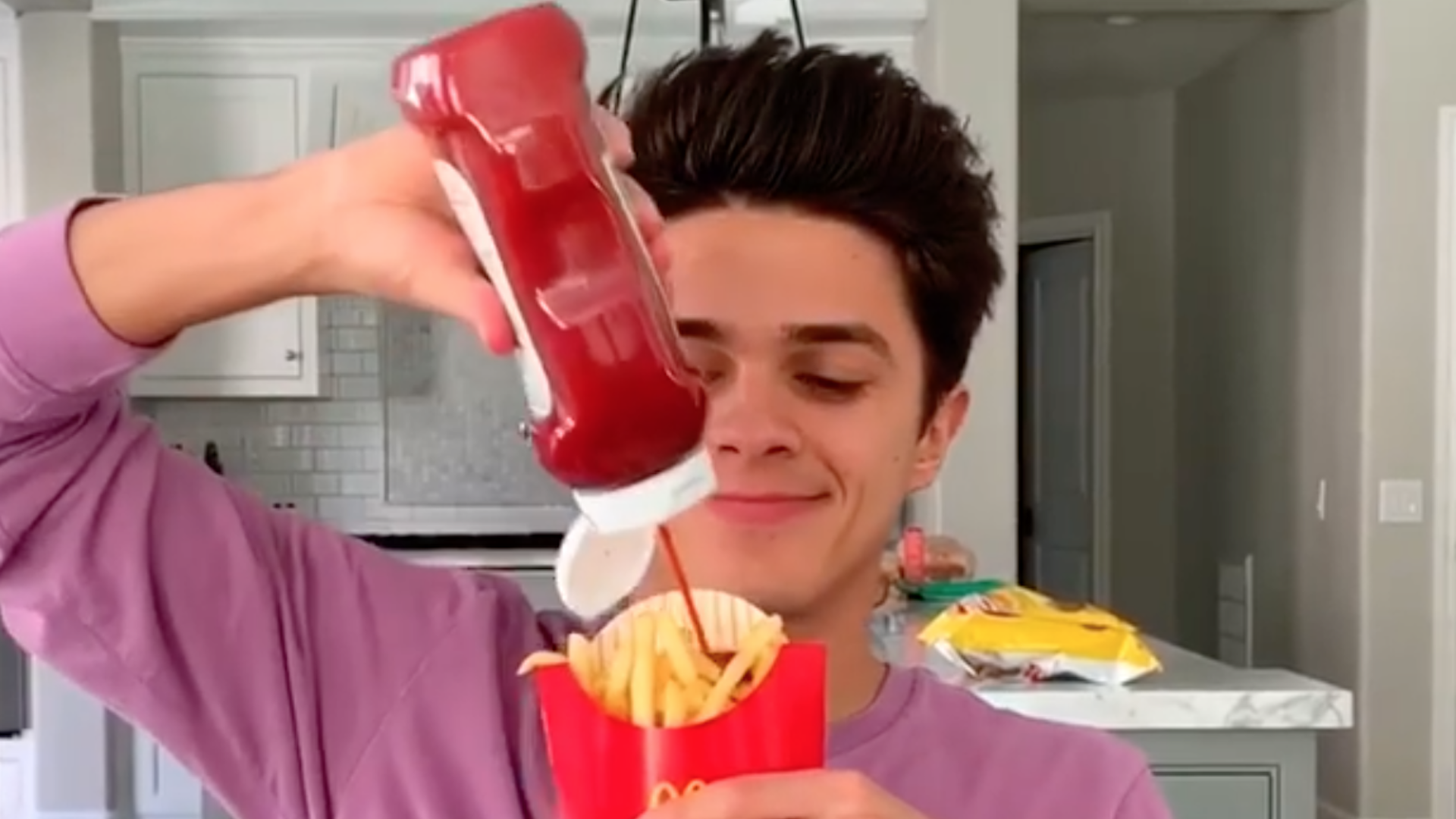 Brent squirting ketchup on fries