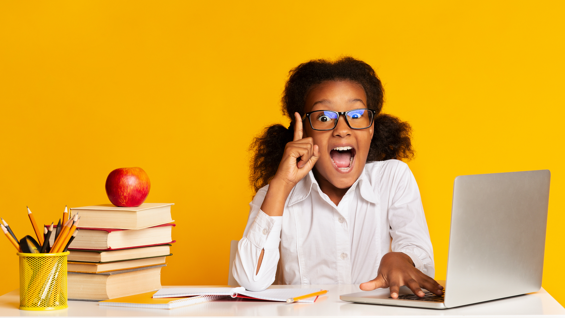 A girl doing her homework with a lot of enthusiasm 