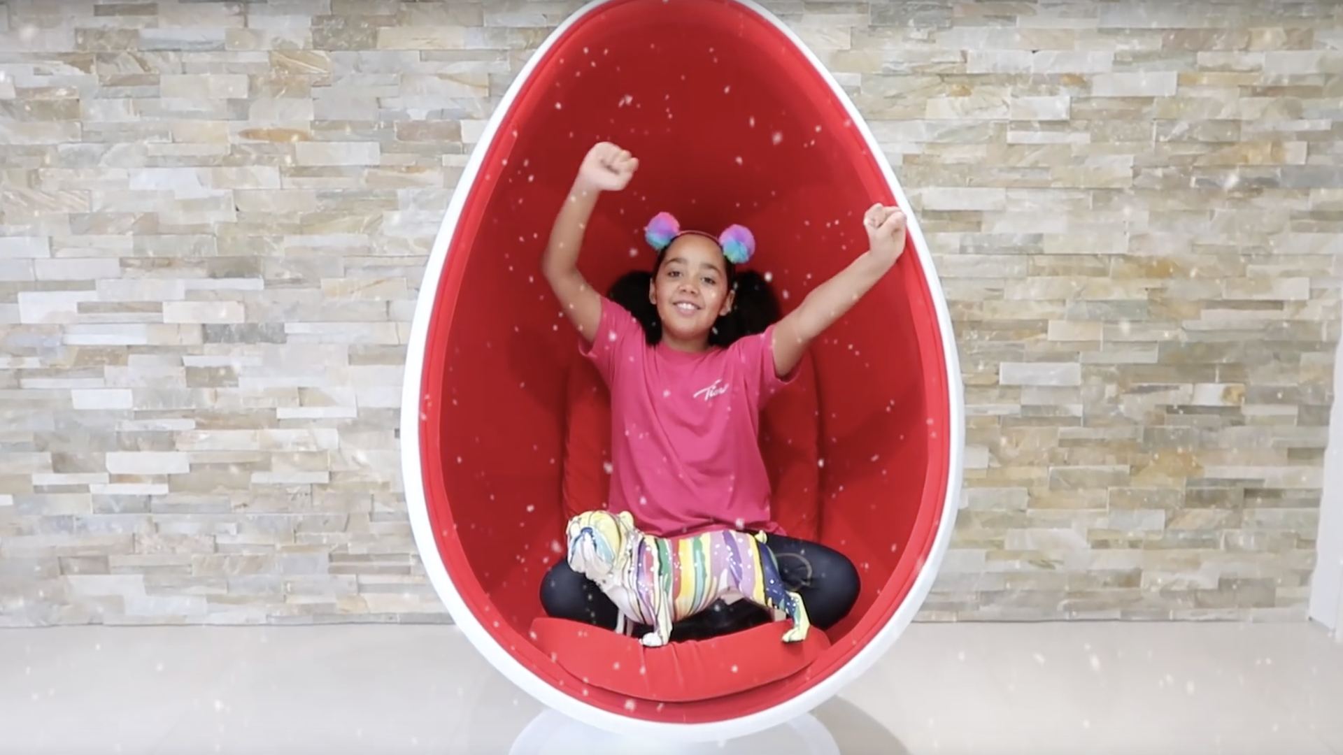 Tiana Wilson sits in a big red egg 