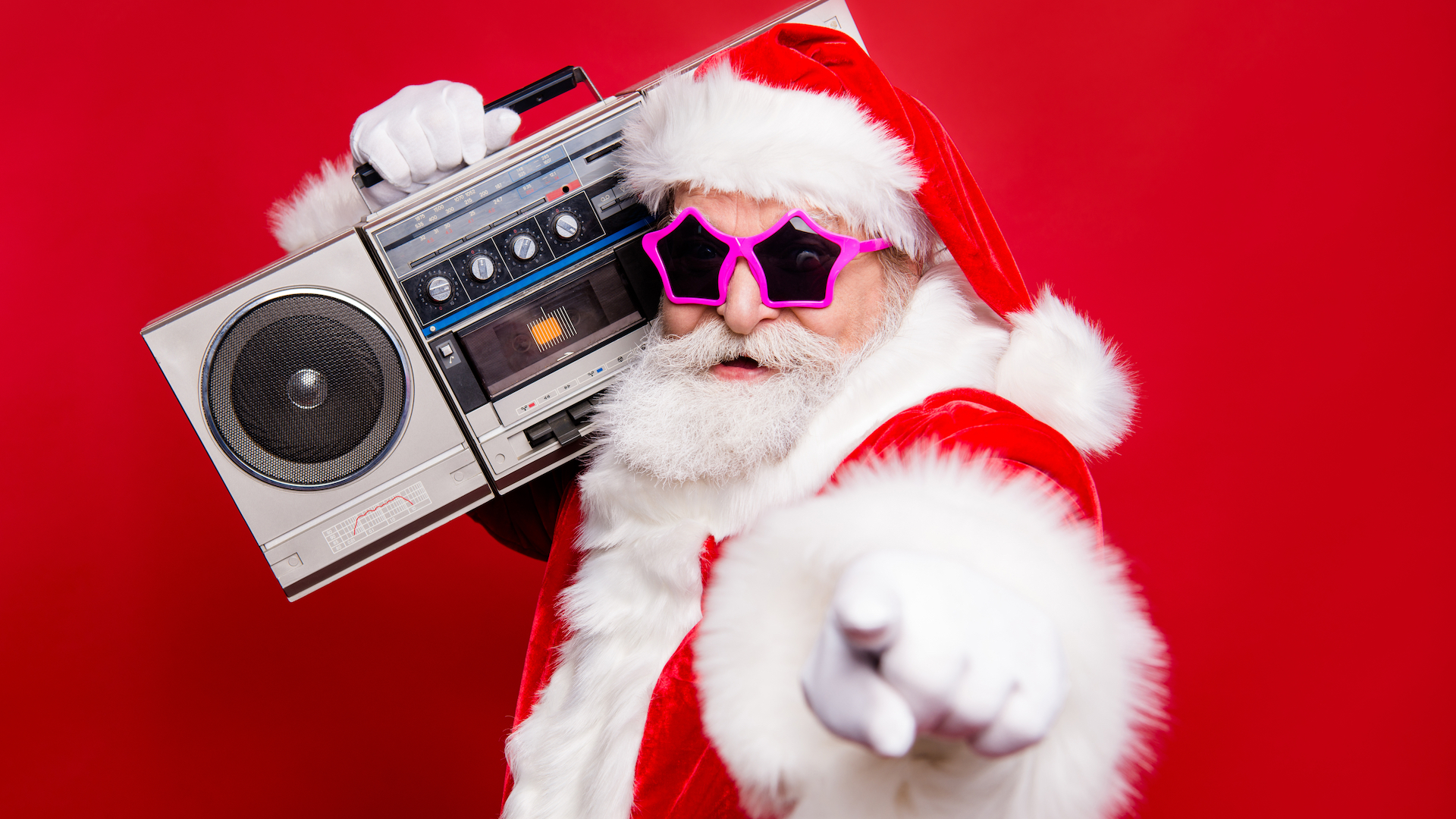 Santa Claus in sunglasses holding a portable stereo