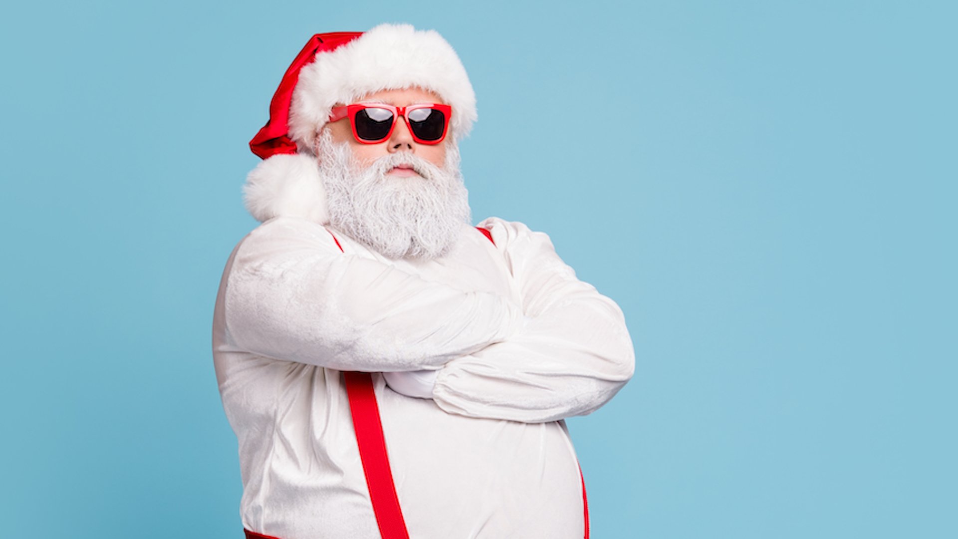 Santa Claus in red braces and sunglasses