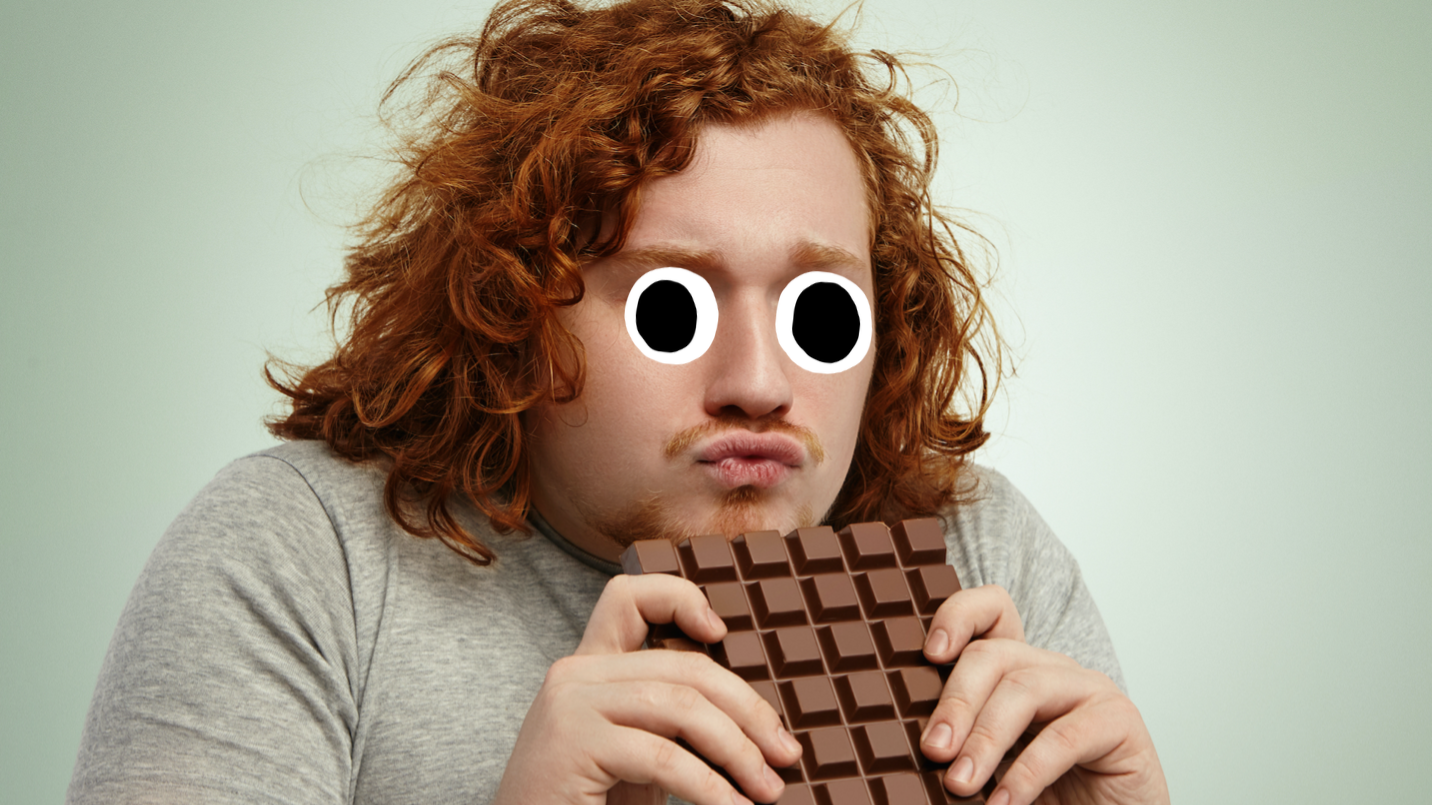 A man enjoying a big bar of chocolate 