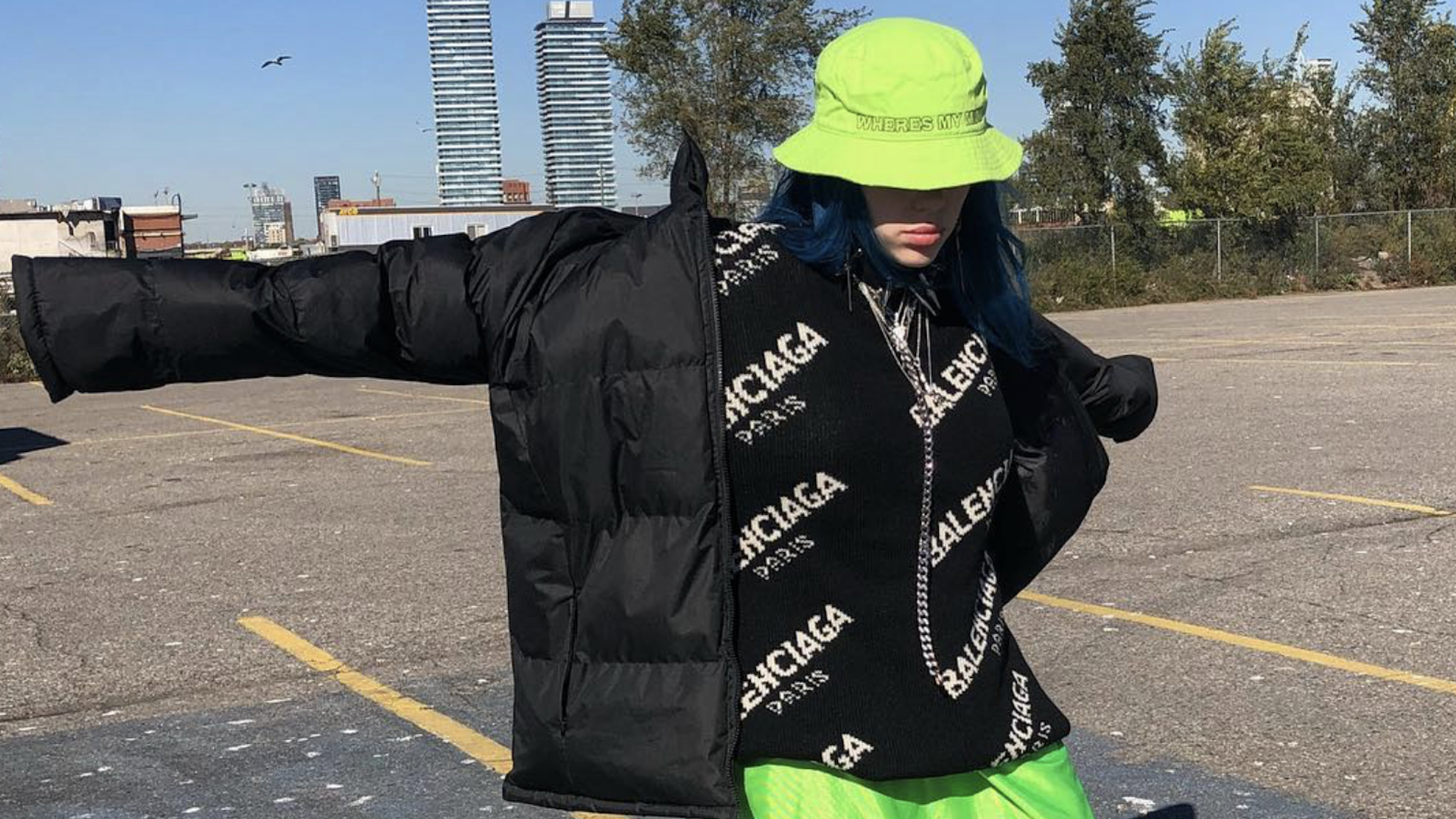 Billie Eilish in a green hat and black coat 
