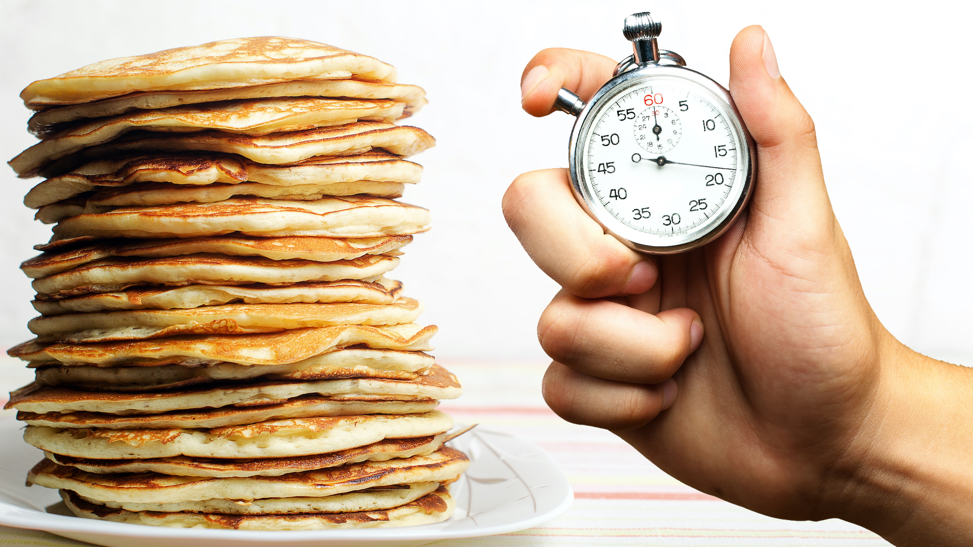 A pancake record with a hand holding a stopwatch