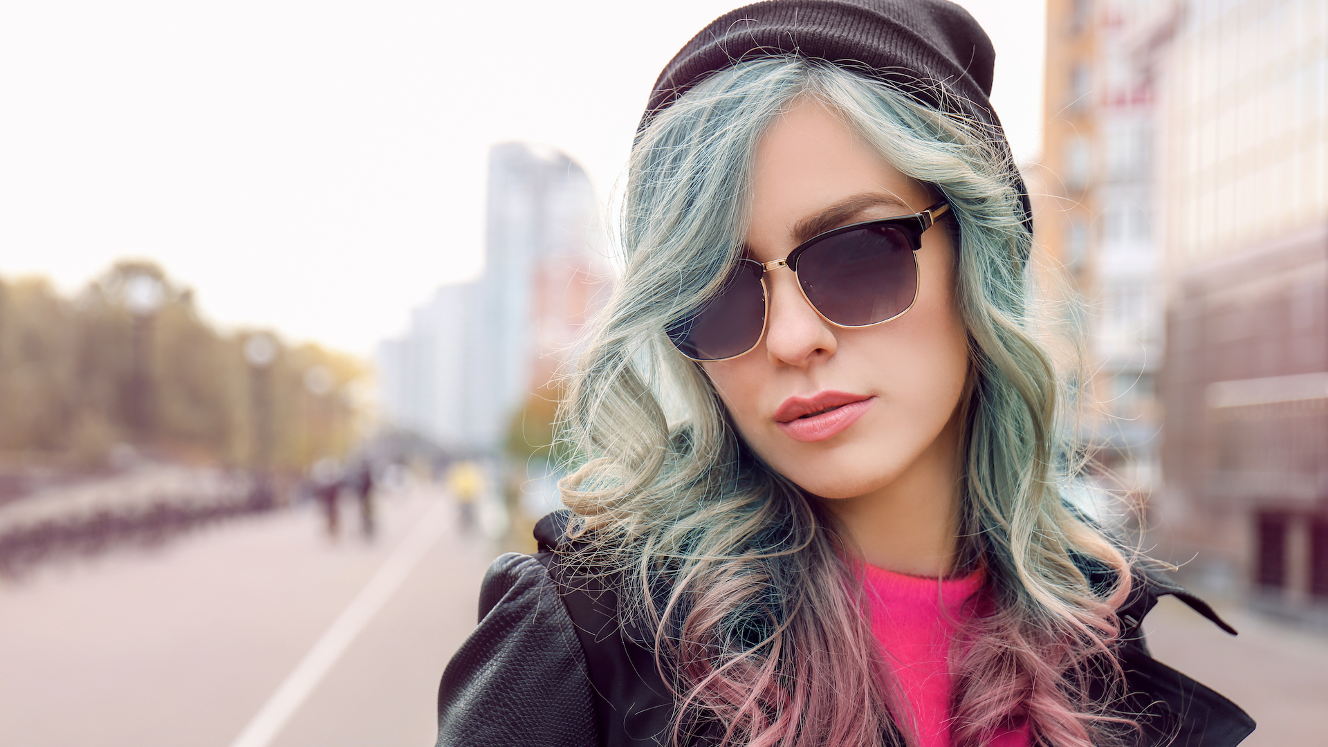 A woman in sunglasses and a beanie