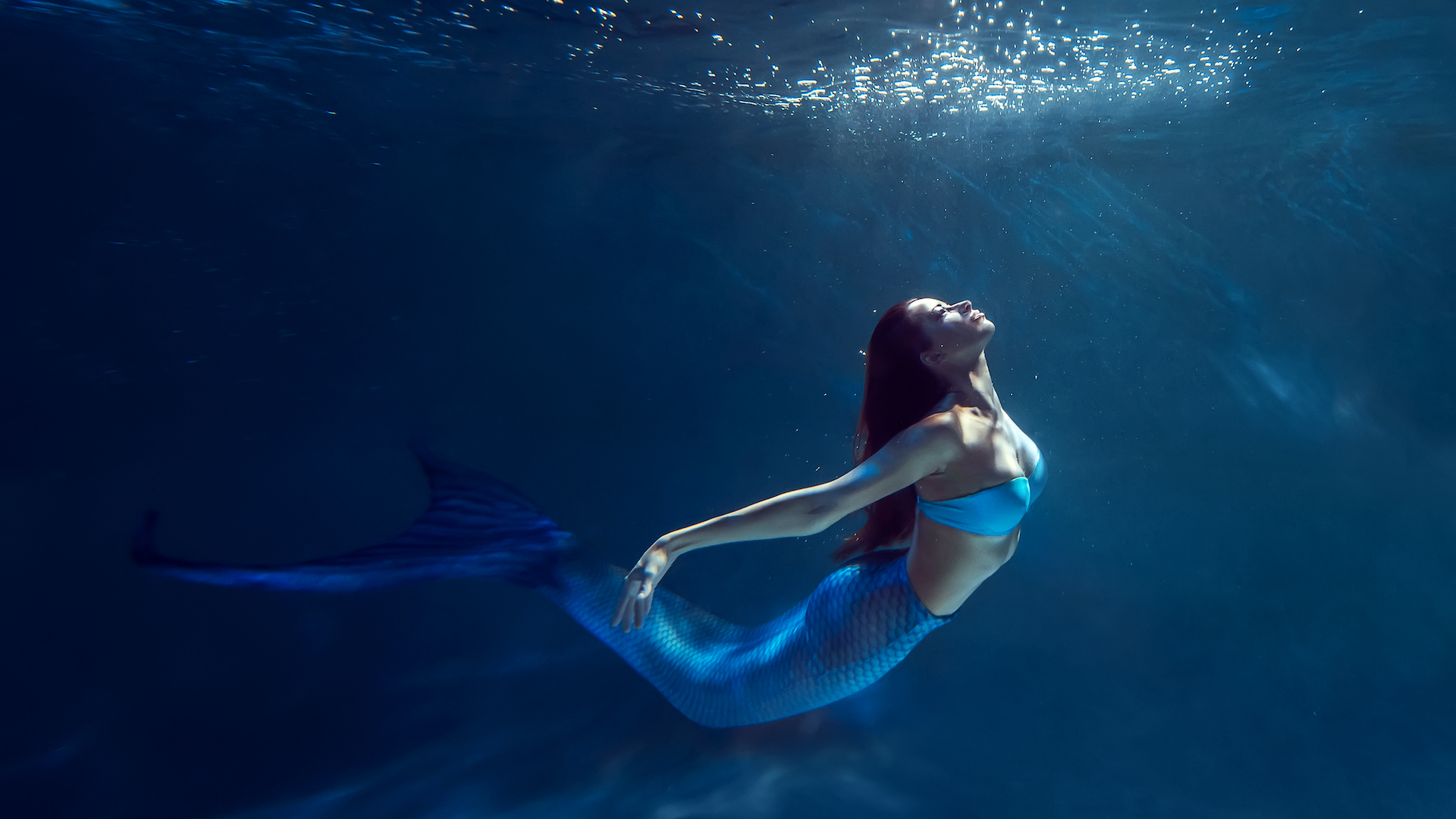 A mermaid swimming in the ocean 