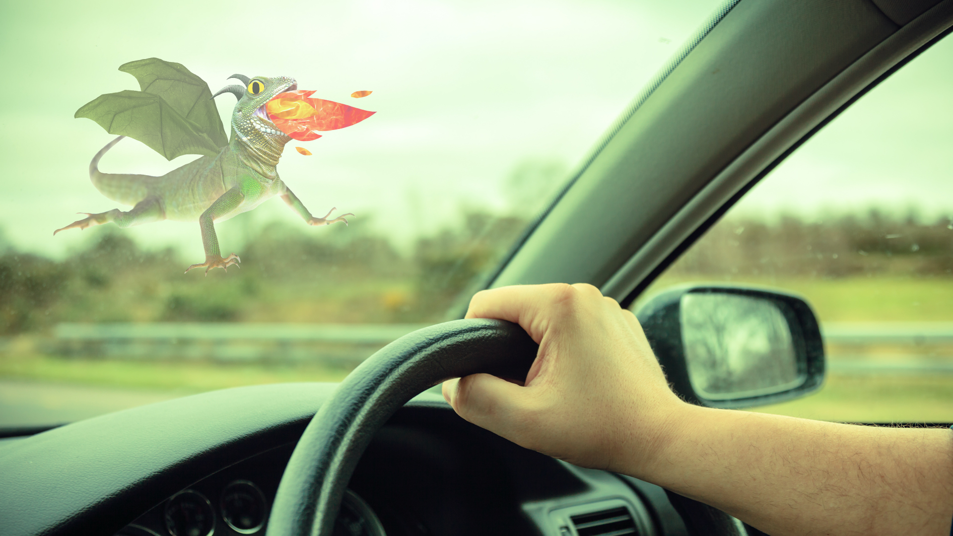 A car dashboard with a dragon in the background