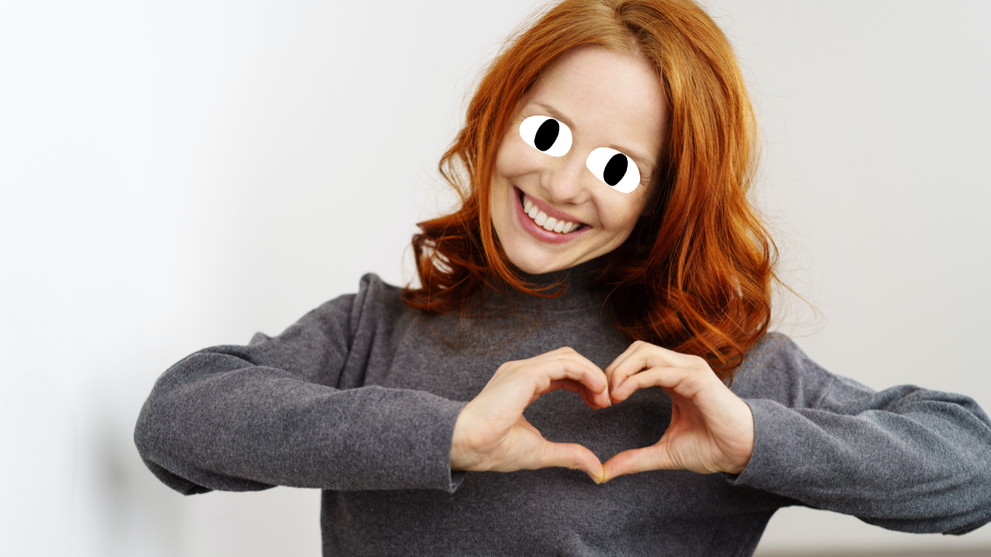 A woman making a heart shape with her hands