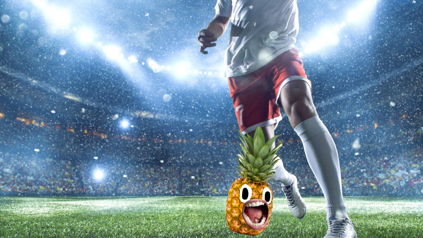 A footballer is about to kick a pineapple