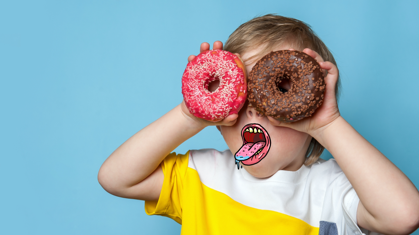 A child holding up donuts to his eyes