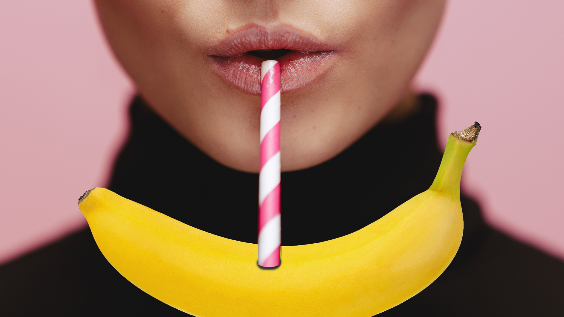 A woman drinking a banana with a straw