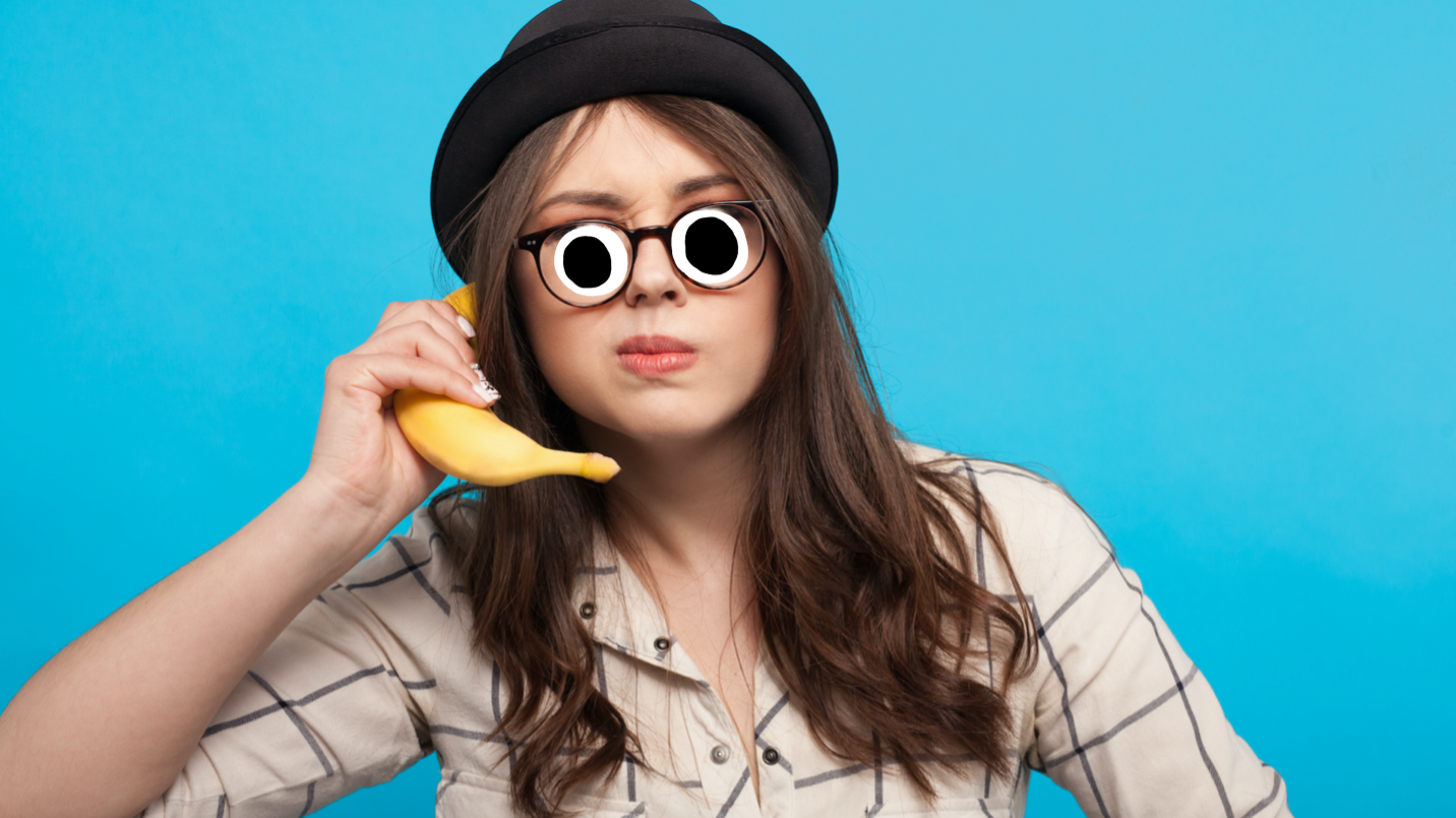 A woman using a banana as a phone