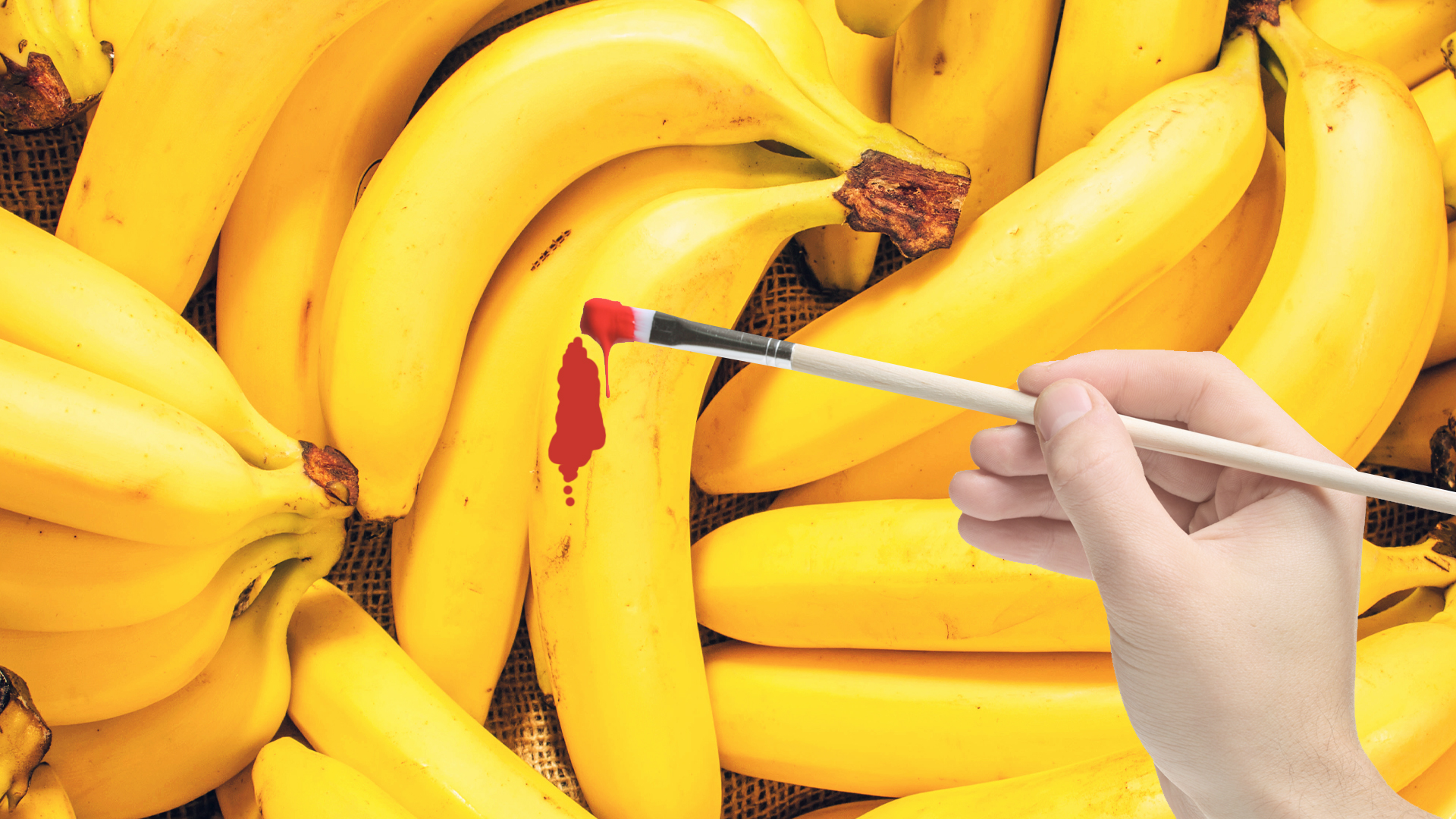A man painting a banana red