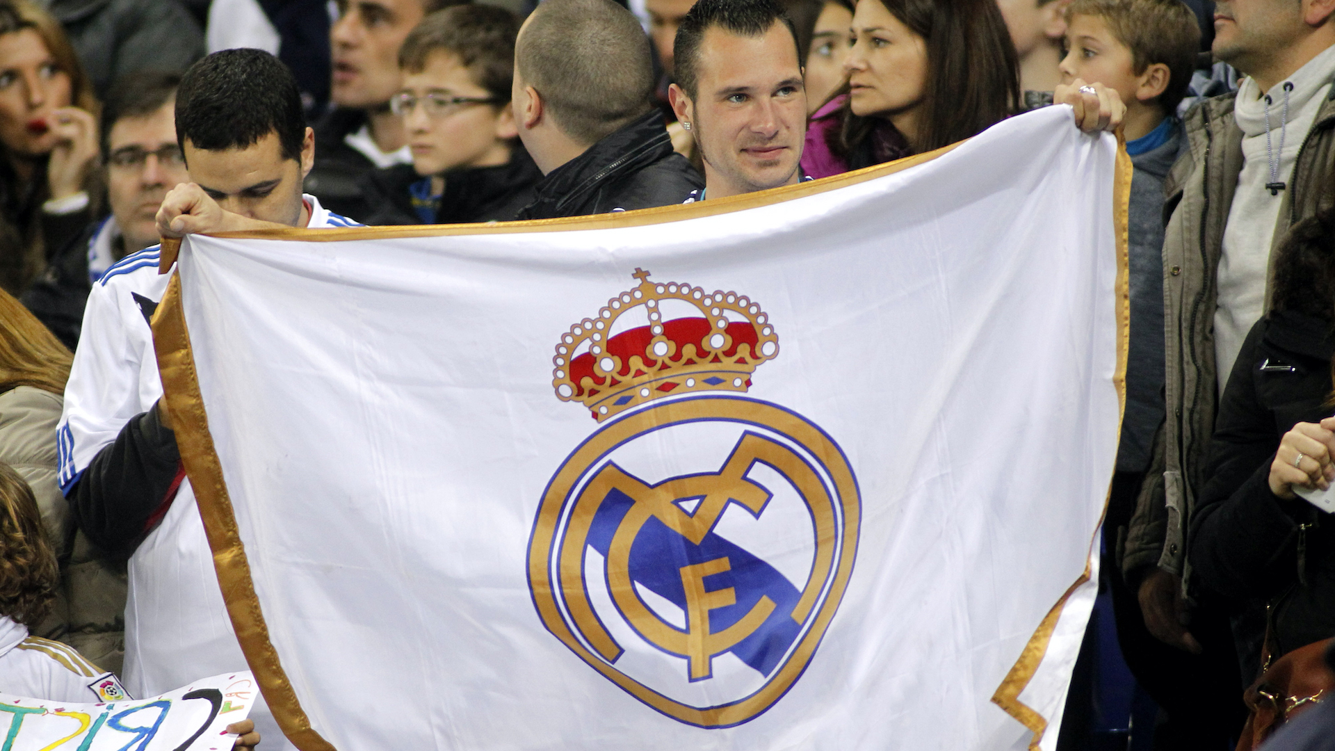 A fan holding a Real Madrid flag