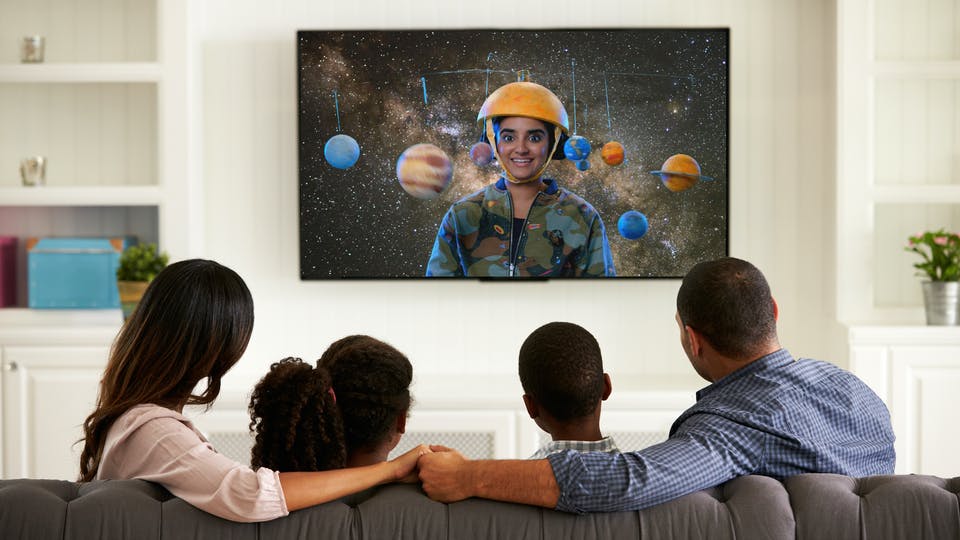 A family watching Brainchild on TV