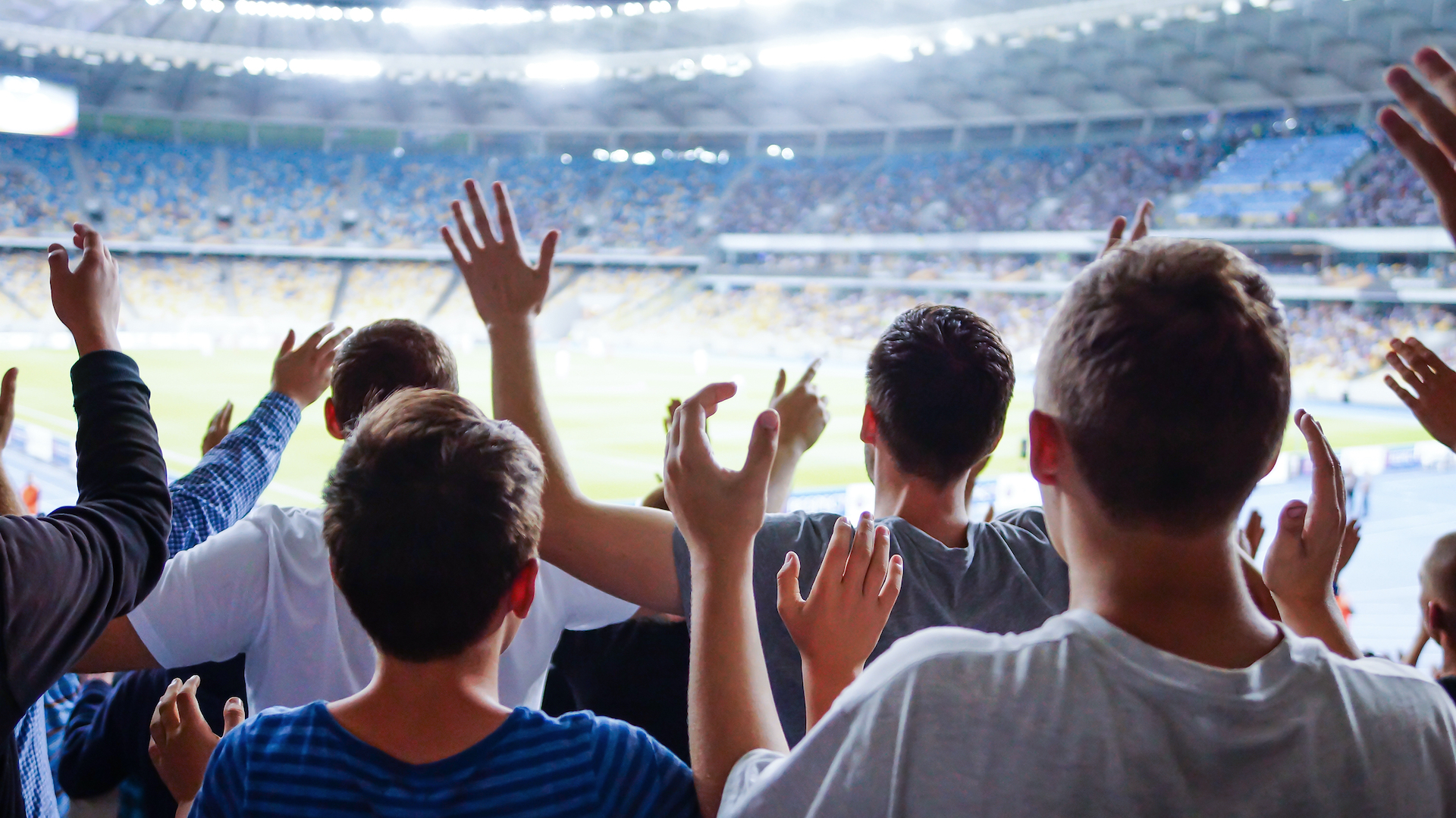 A cheering football crowd in a big stadium