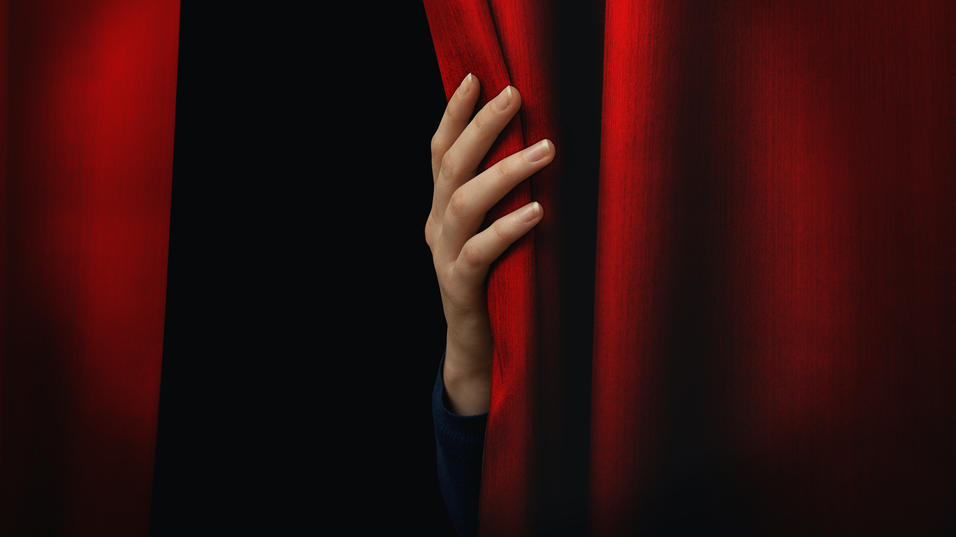 A hand holding a curtain