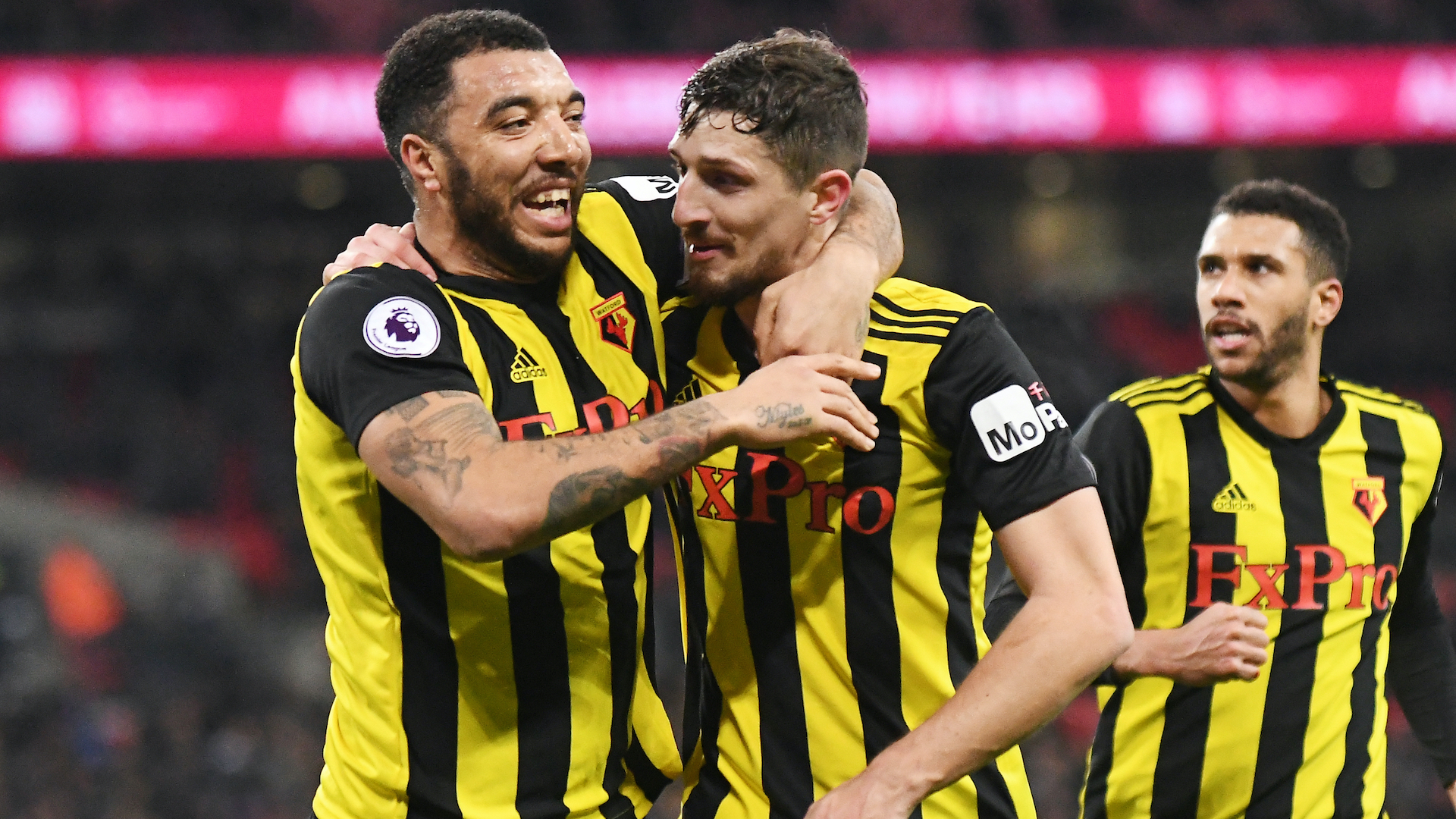 Craig Cathcart celebrates with Troy Deeney after scoring a goal during the 2018/19 Premier League game between Tottenham Hotspur and Watford FC at Wembley Stadium.