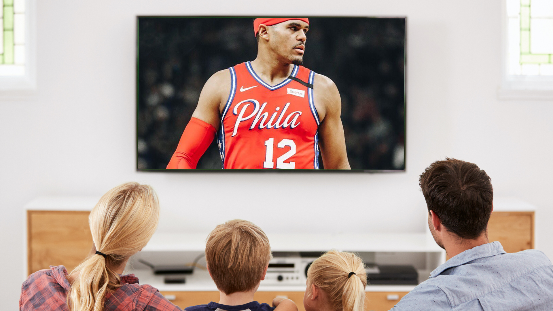 A family watching a basketball game on TV