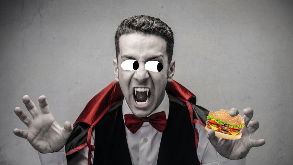 Dracula eating a burger
