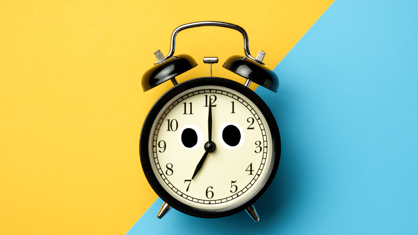 Alarm clock on yellow and blue background