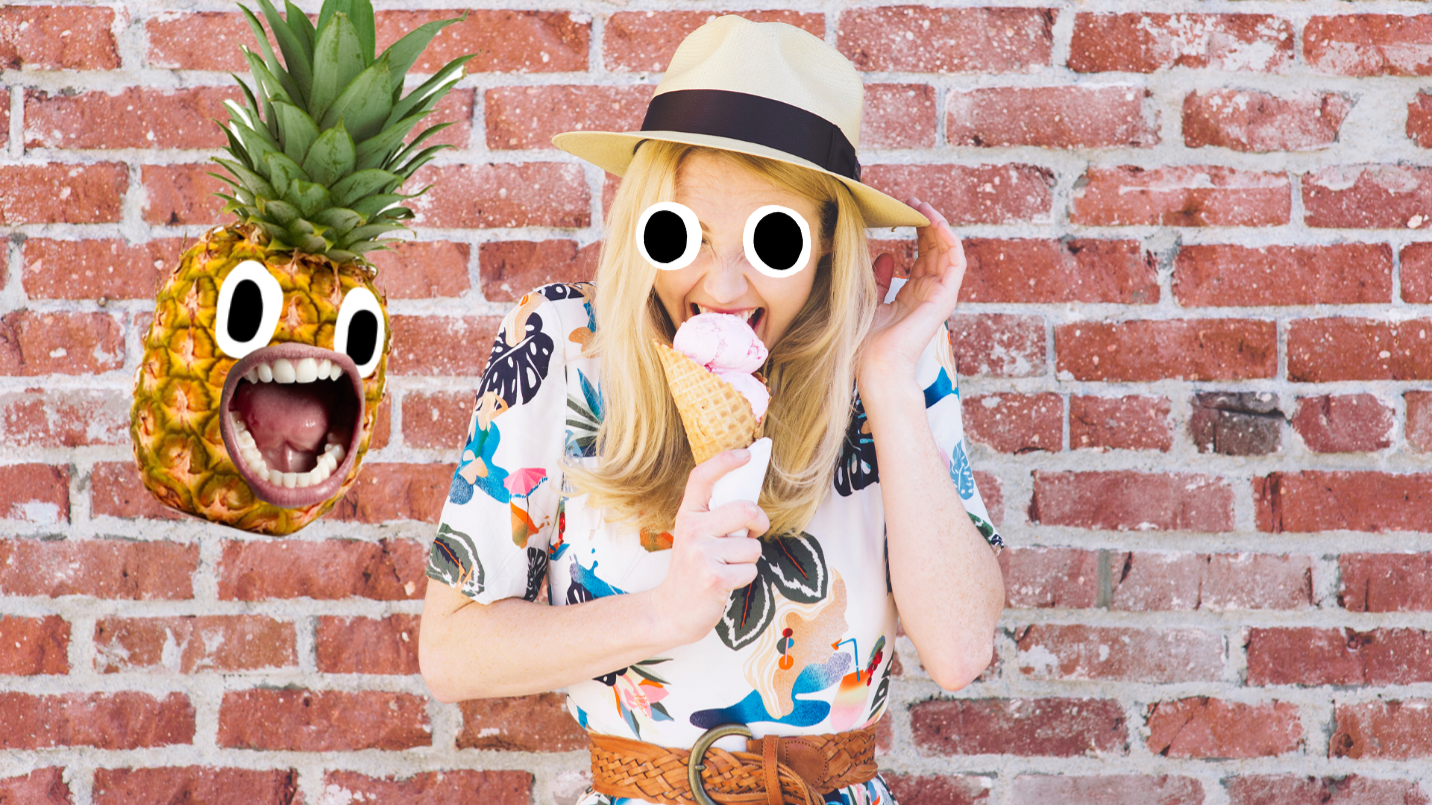 Woman eating ice cream on brick wall with pineapple