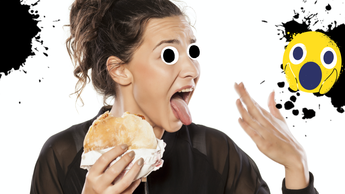 A person eating a spicy sandwich