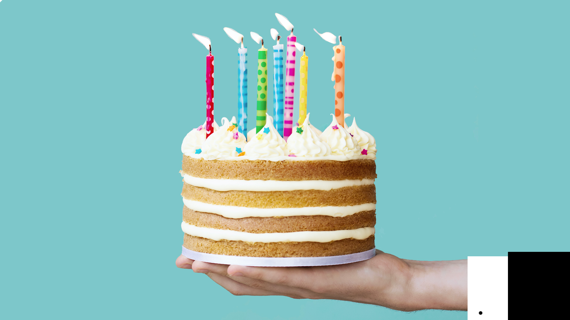 A person holding a delicious birthday cake