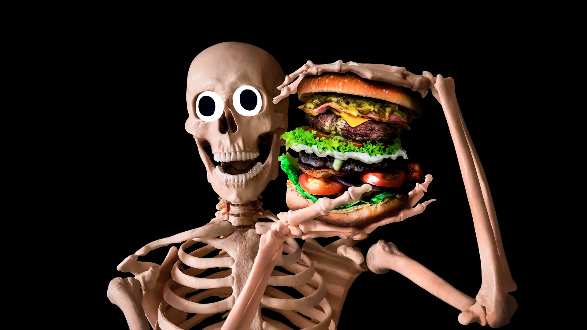 Laughing skeleton holding a huge hamburger