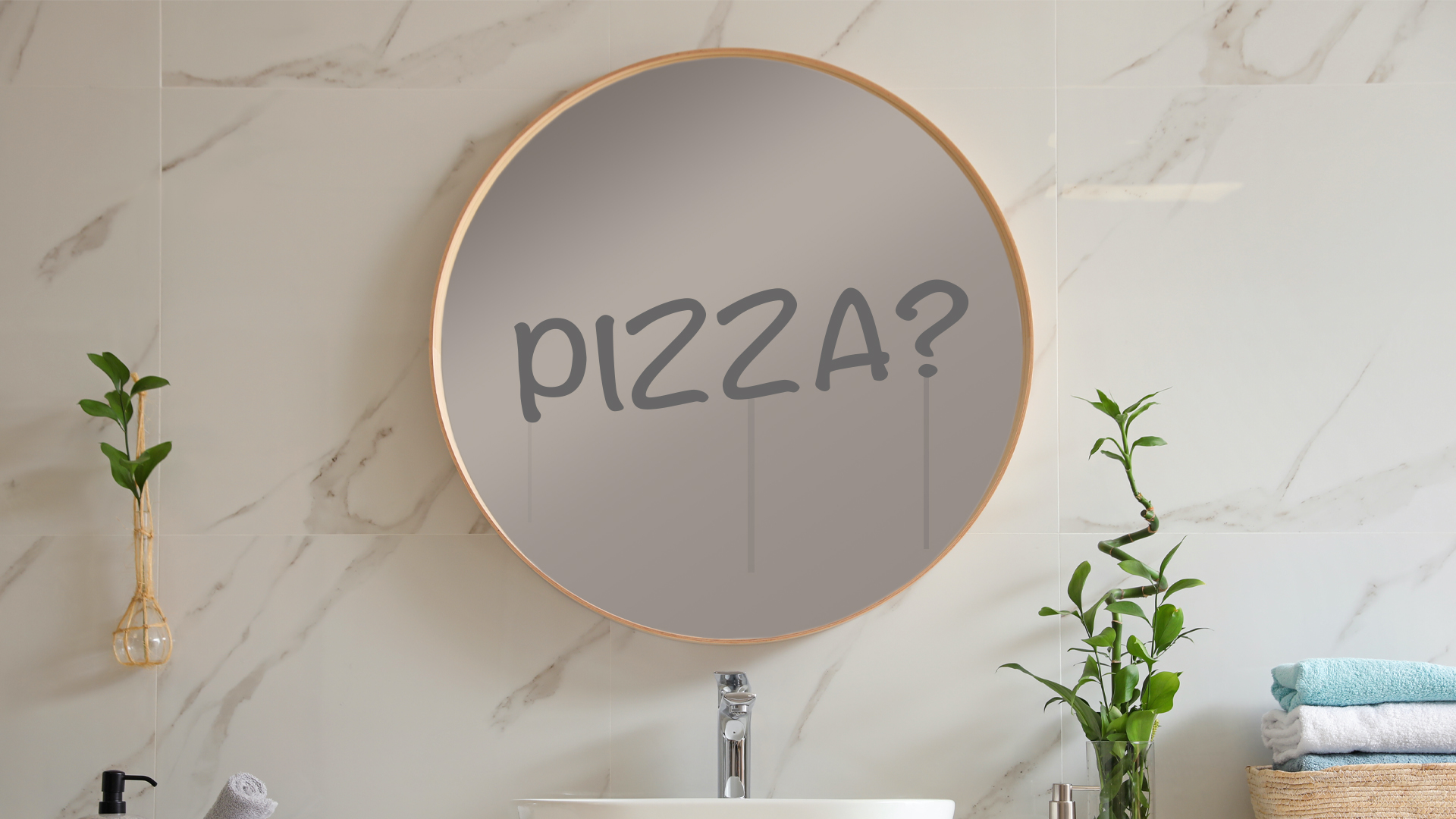 The word pizza written on a bathroom mirror 