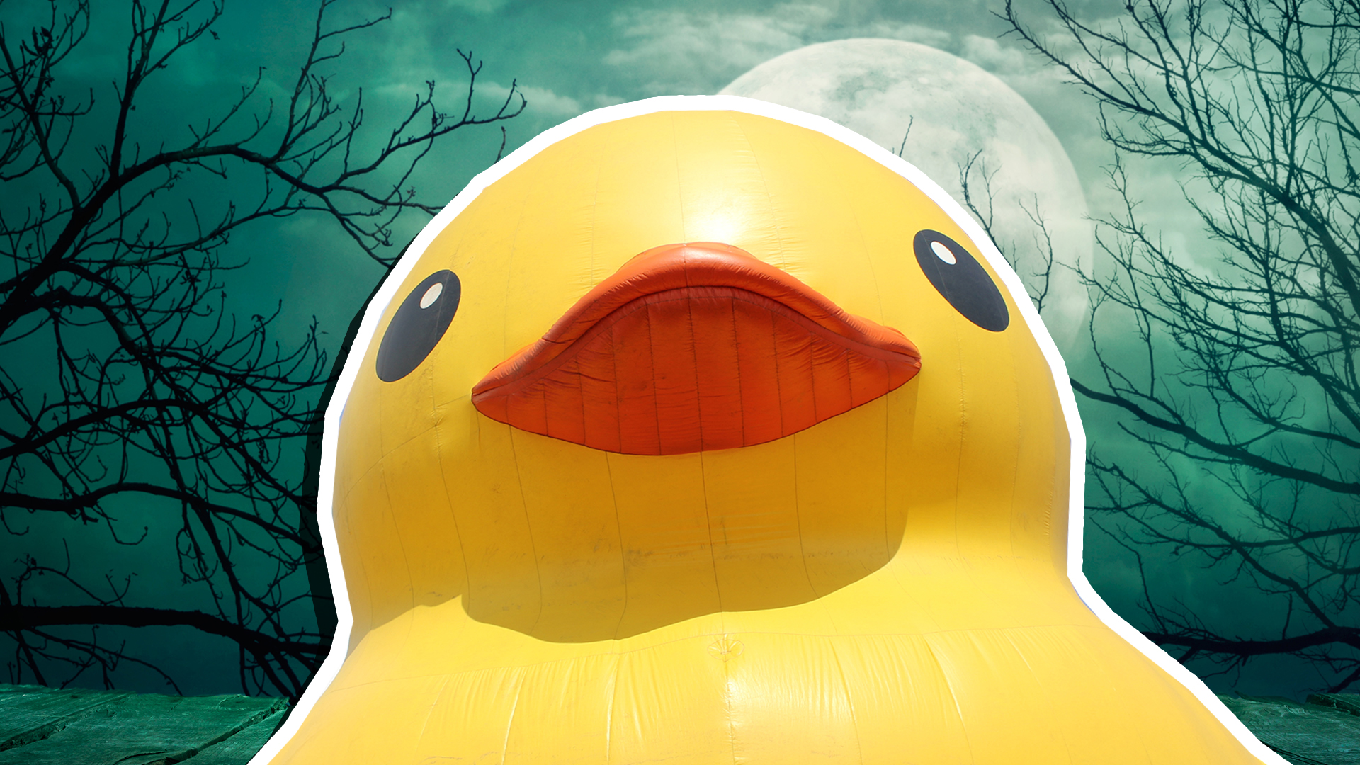 Large yellow inflatable duck in front of a full moon