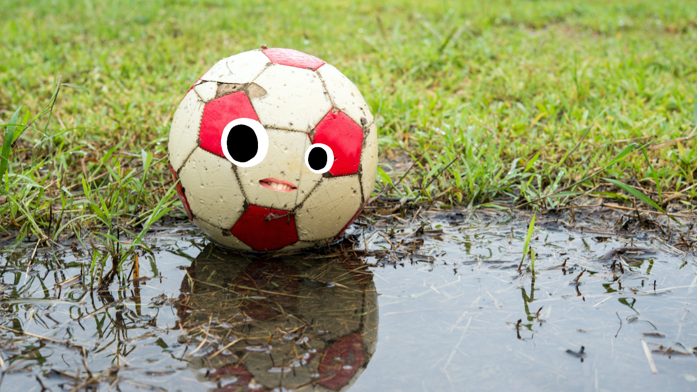 A football in a muddy puddle