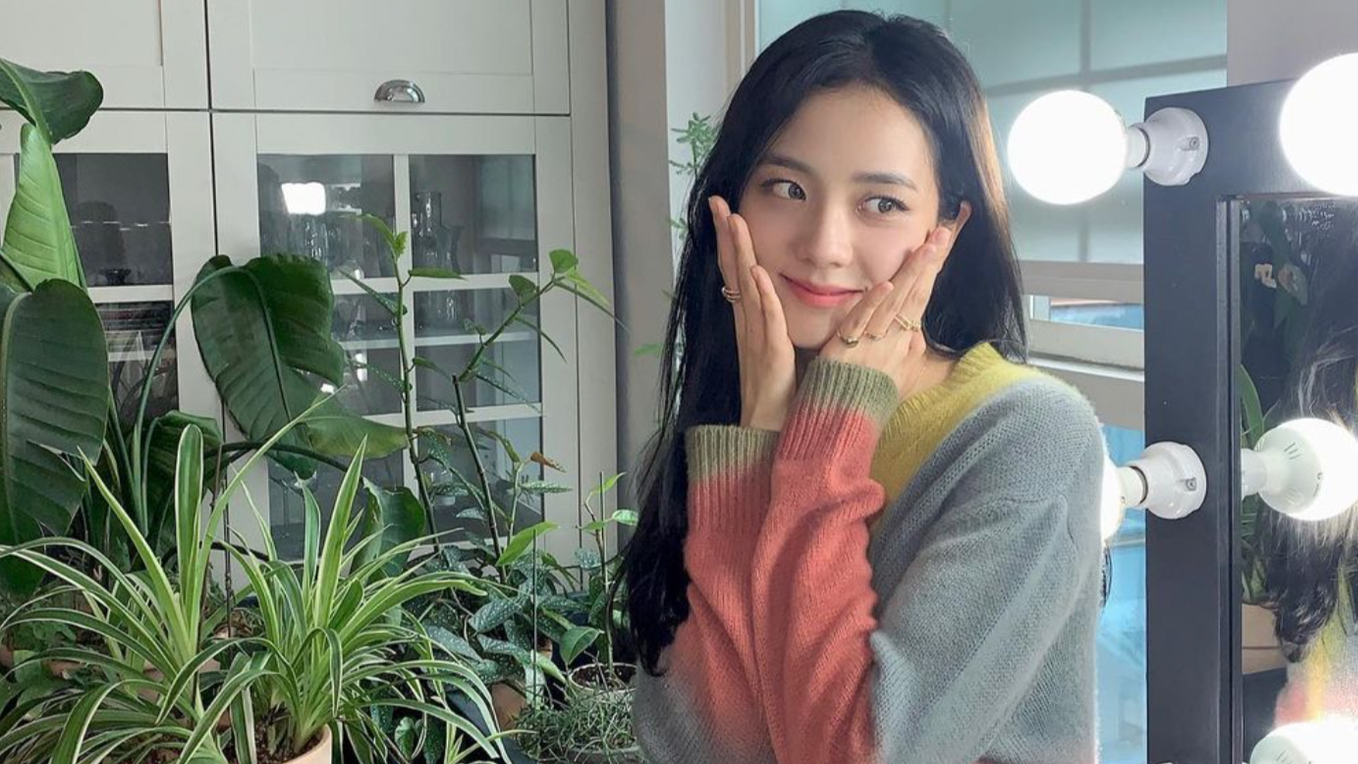 Jisoo in a kitchen surrounded by plants 